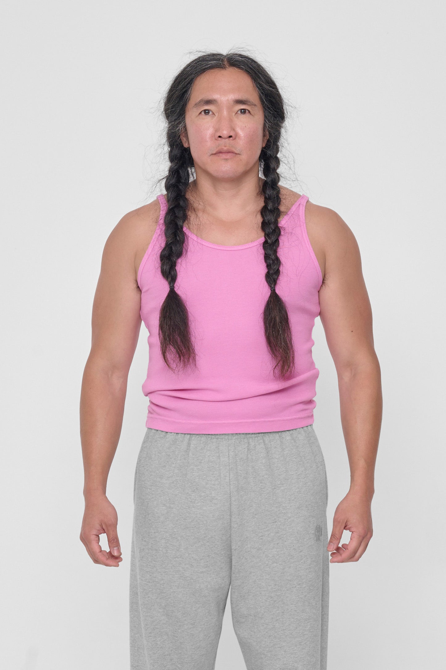 A 5'11" man in a size L Pixie Rib Tank. Fabric bunched up for hem to rest on his upper hips.