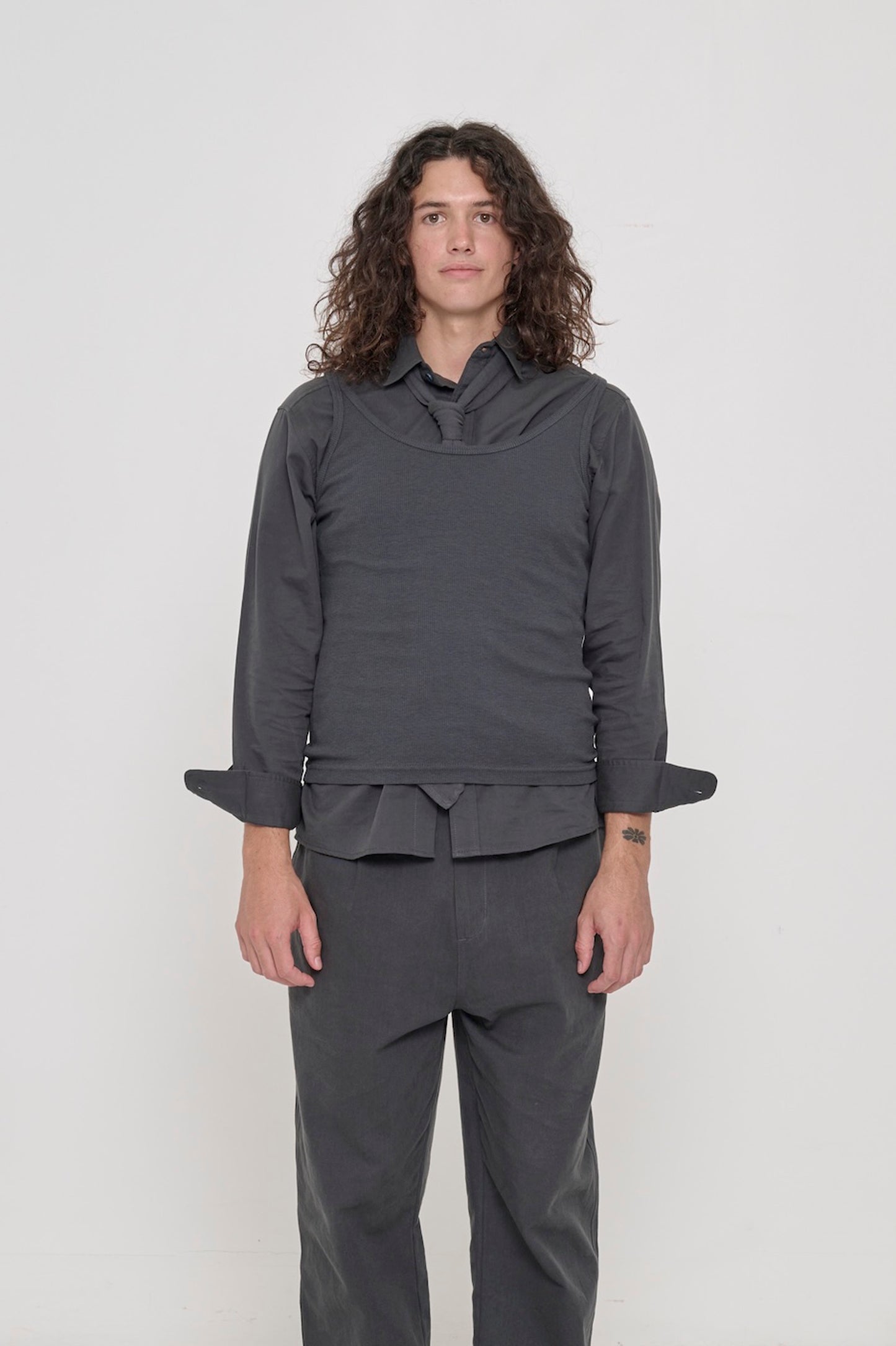 Front view of a 6' person wearing a size S Slate Rib Tank. Hem rests on their upper hips.