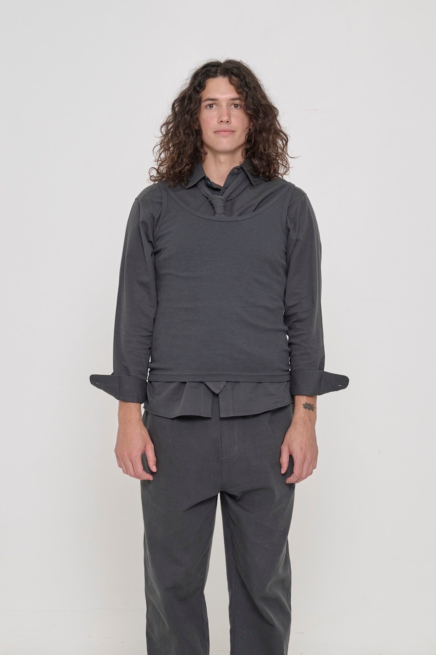 Front view of a 6' person wearing a size S Slate Rib Tank. Hem rests on their upper hips.