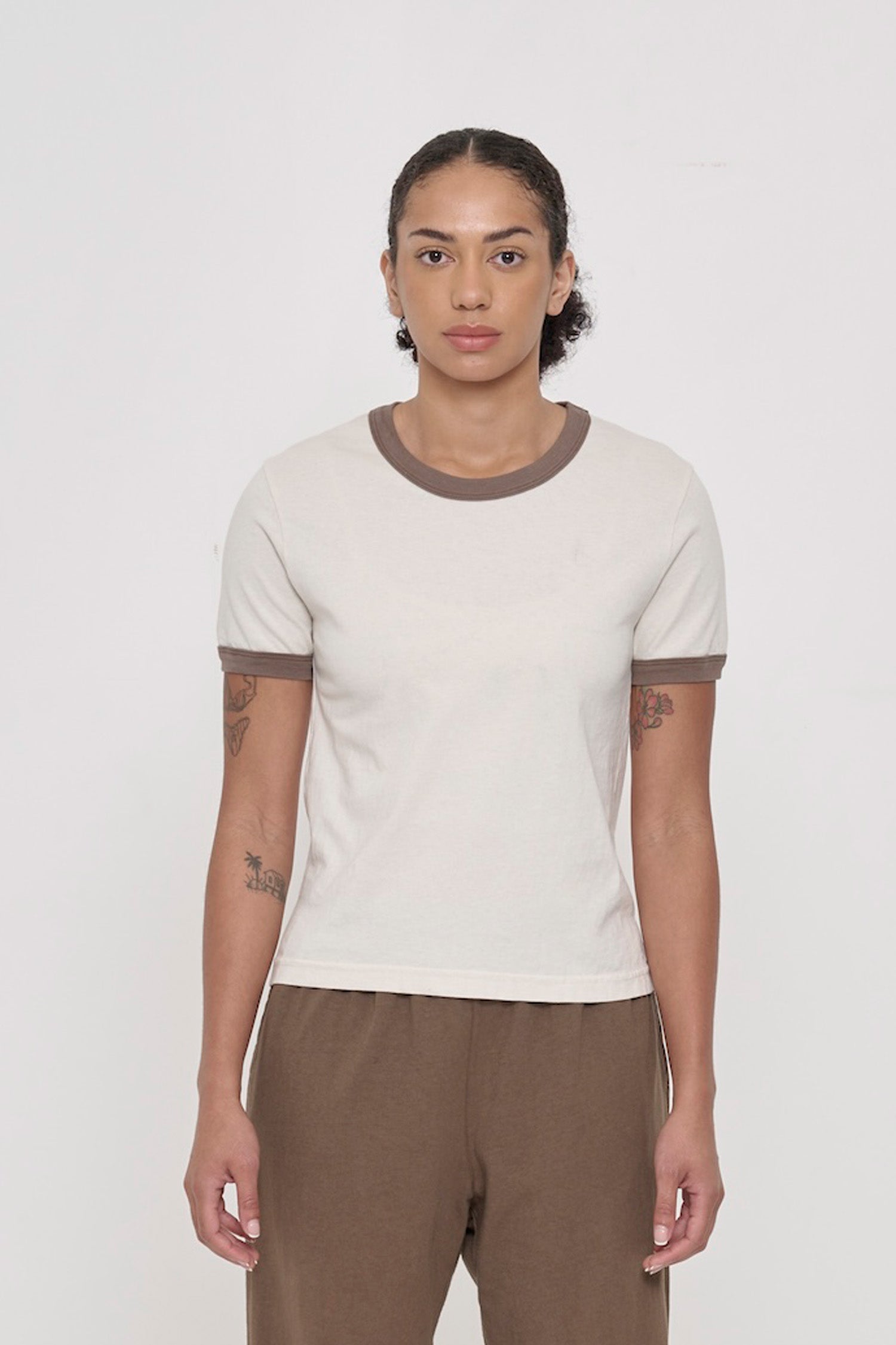 Front view of a 5'8" woman wearing a Ringer Trash Tee in Dry Soil. Hem hits her upper-middle hip.