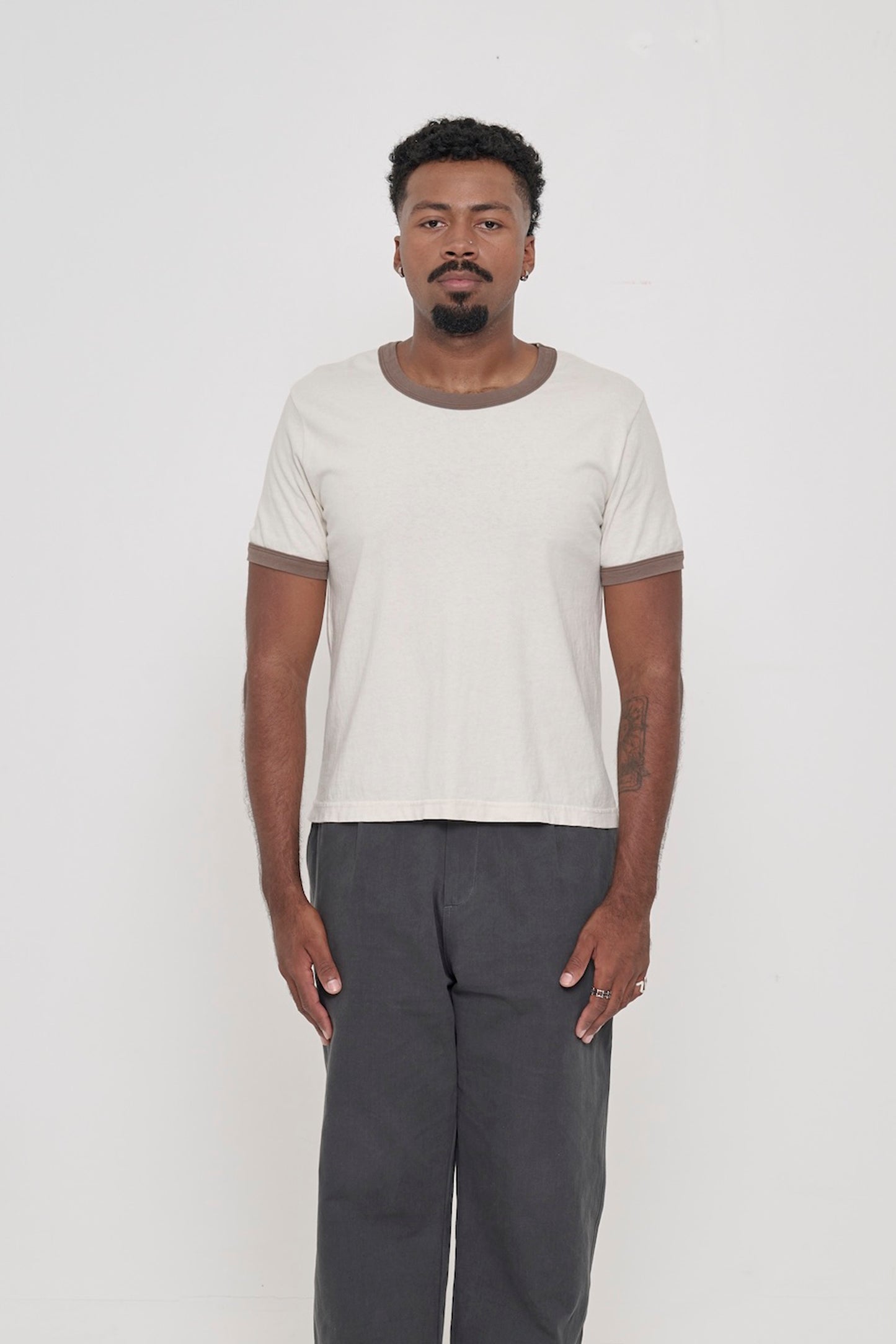 Front view of a 6'2" man wearing a Ringer Trash Tee in Dry Soil. Hem hits his upper hip.