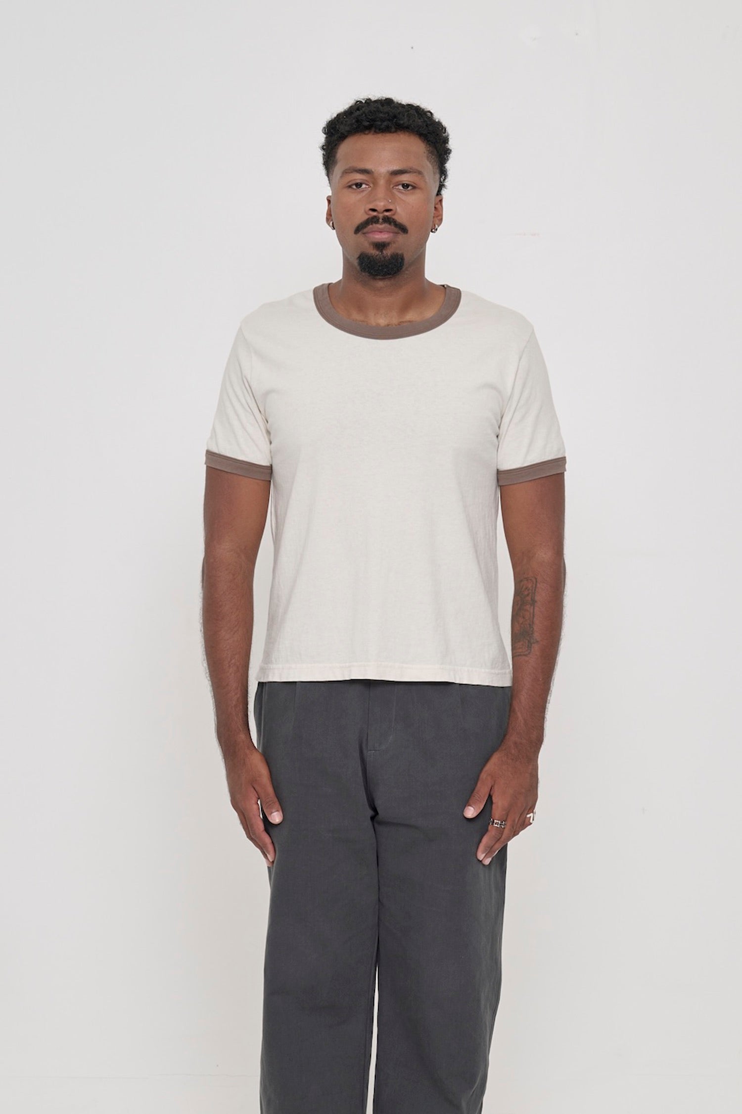 Front view of a 6'2" man wearing a Ringer Trash Tee in Dry Soil. Hem hits his upper hip.