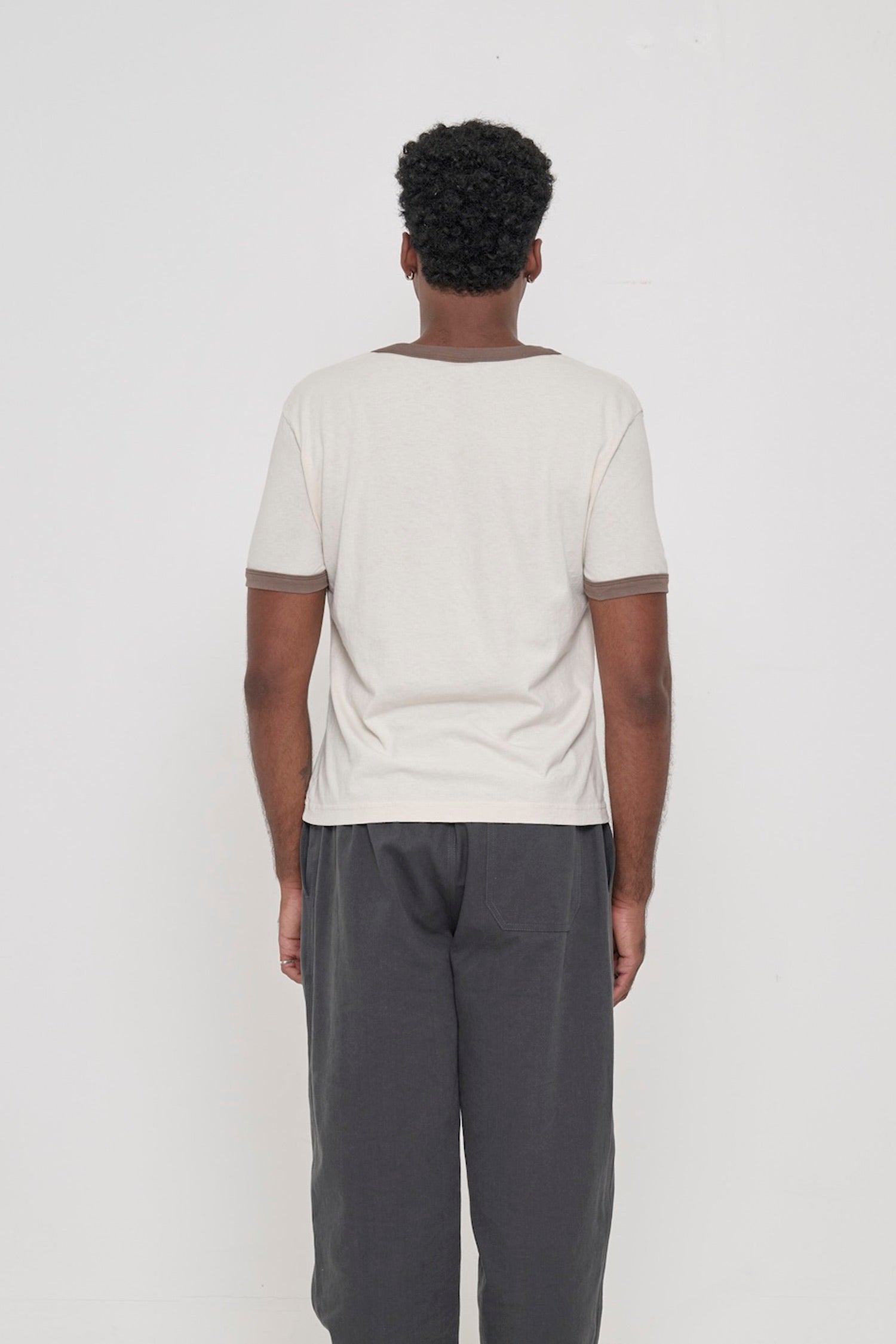 Dry Soil Ringer Trash Tee, back view on a man. Relaxed slim fit throughout.  
