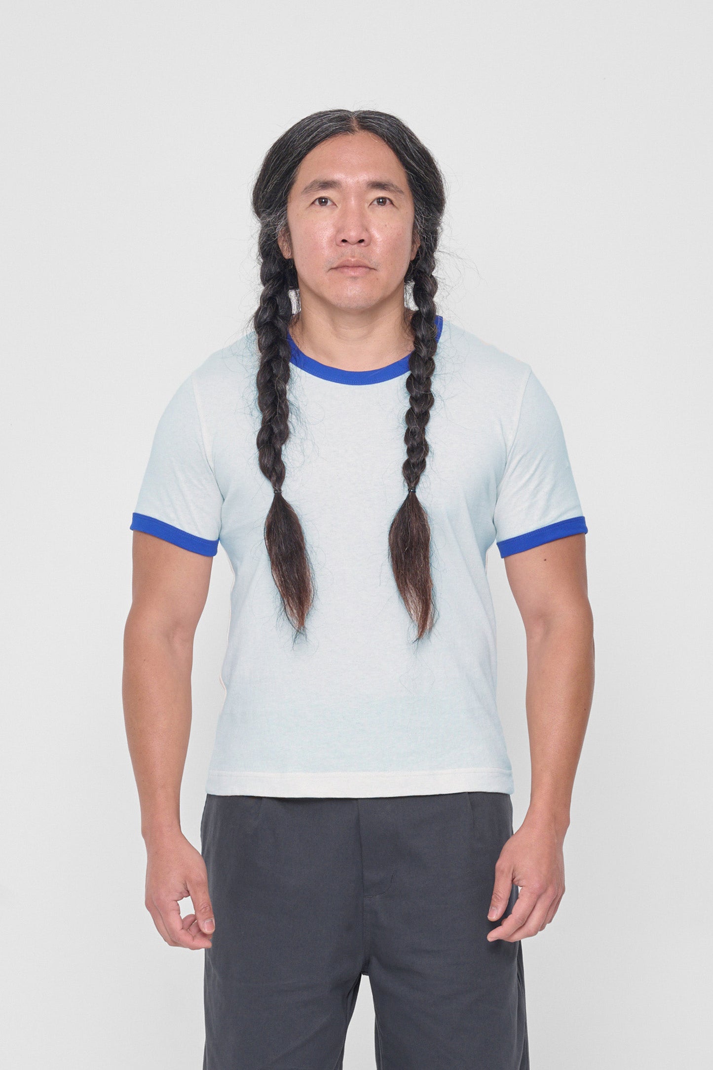 A 5'11" man in a size L Lapis Ringer Trash Tee. Hem hits his upper hip.