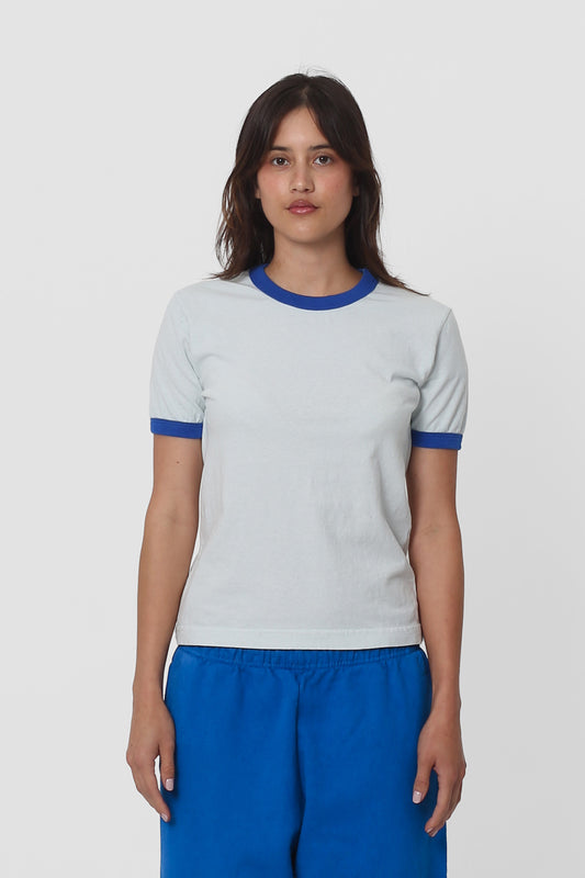 A 5'5" woman wearing a Ringer Trash Tee in Lapis. Hem hits her hip.