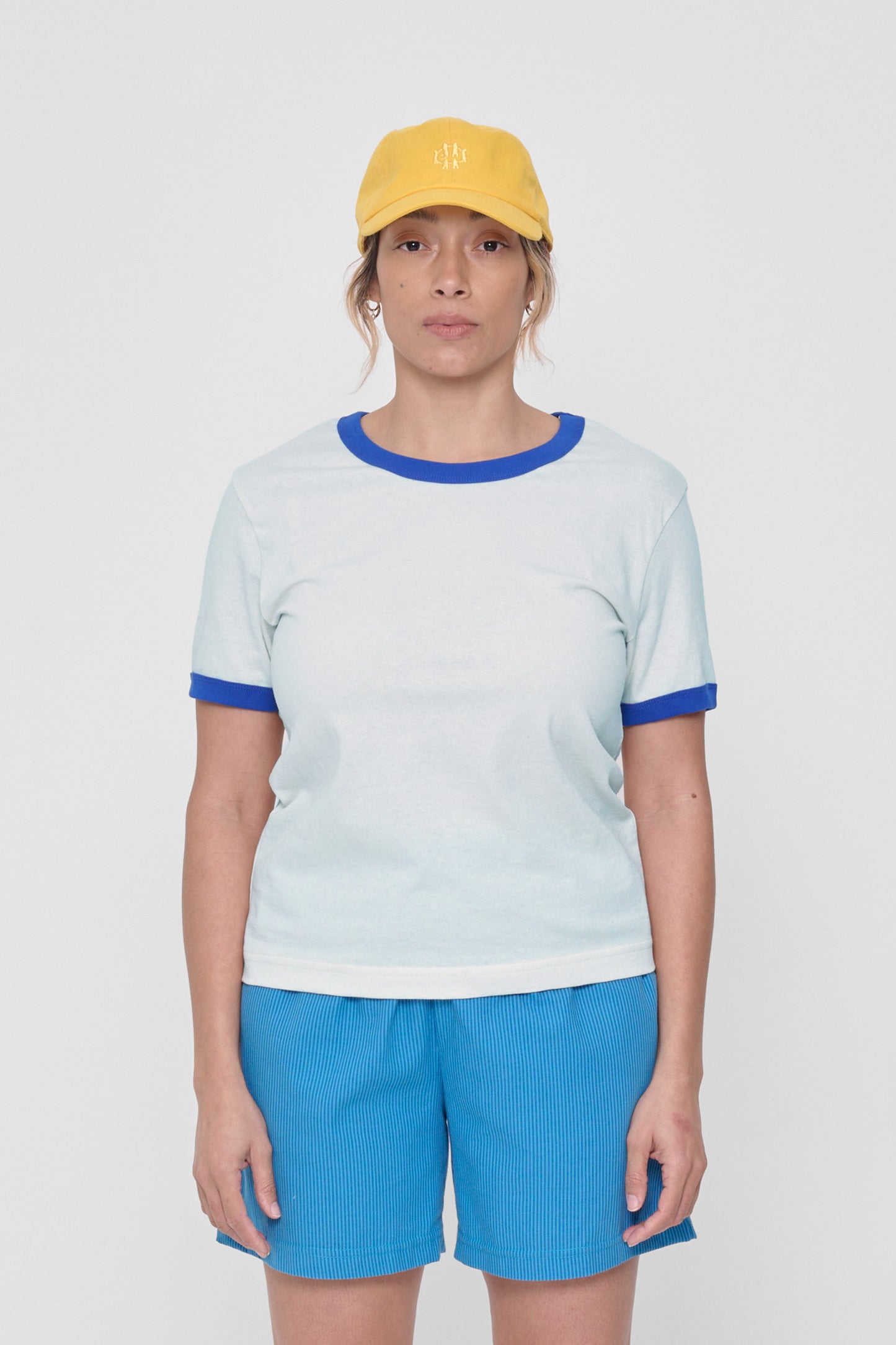 A 5'4" woman in a size M Lapis Ringer Trash Tee. Hem hits her middle hip.