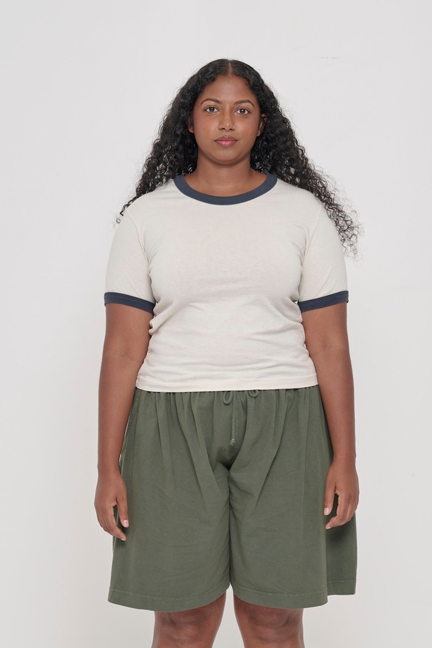 Front view of a 5'8" person wearing a Ringer Trash Tee in Slate. Hem hits her upper-middle hip.