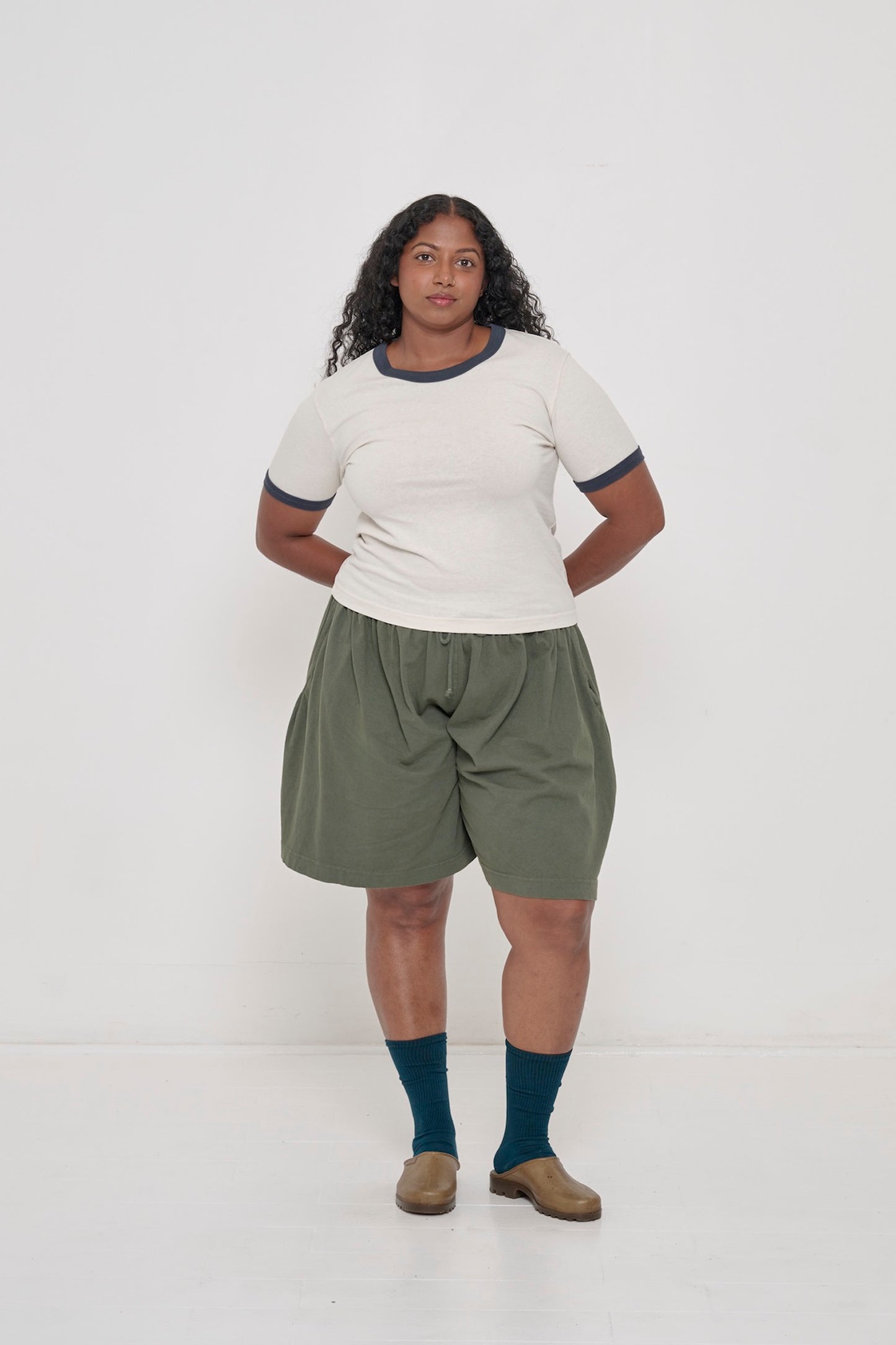 A woman wearing a Slate Ringer Trash Tee  with Pine Tubular Shorts.