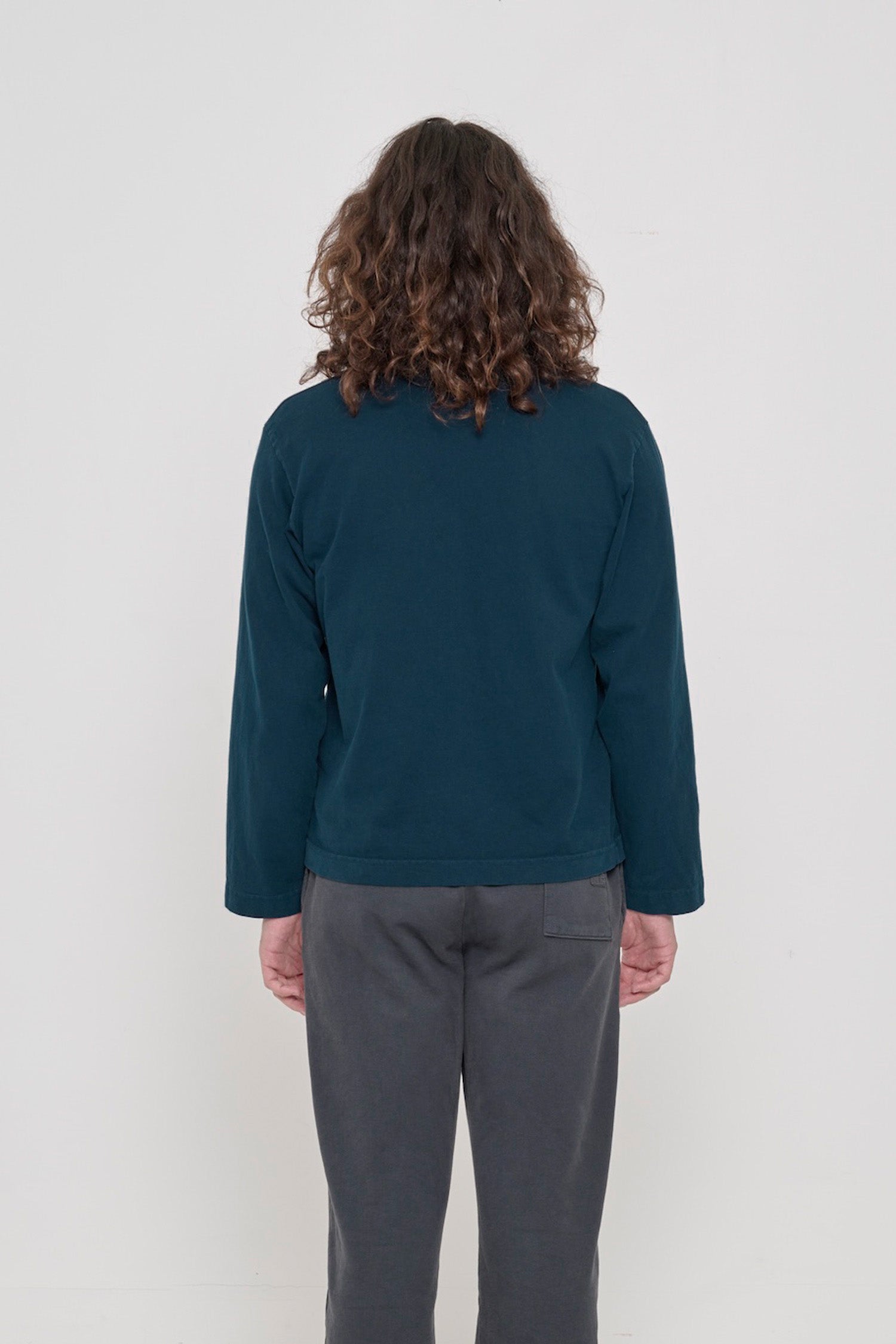 Juniper Rugby Trash Polo, back view on a person. Boxy fit.