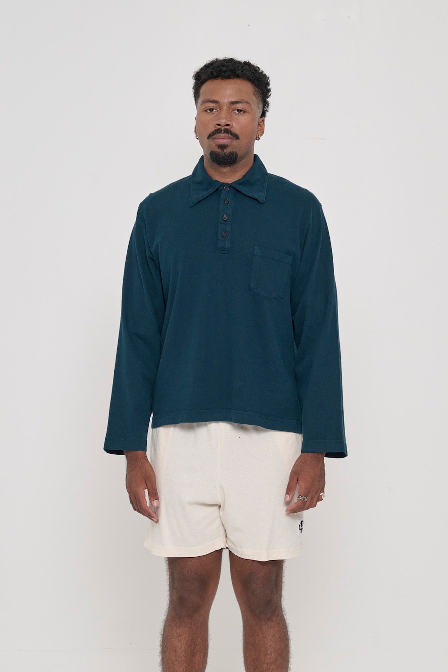 Front view of a 6'2" person wearing a size L Rugby Trash Polo in Juniper. Hem hits lower-mid hip.
