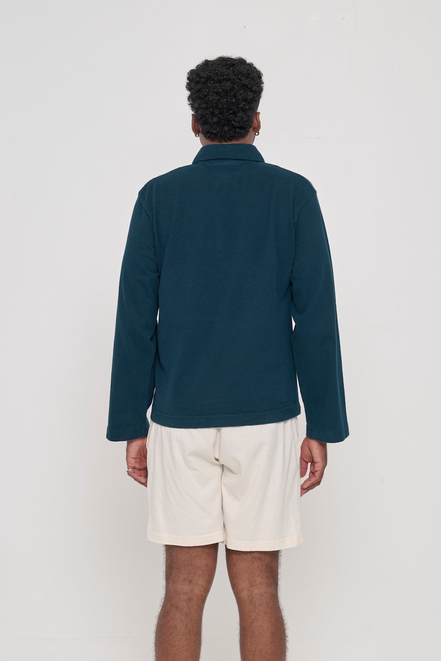 Juniper Rugby Trash Polo, back view on a person. Boxy fit.