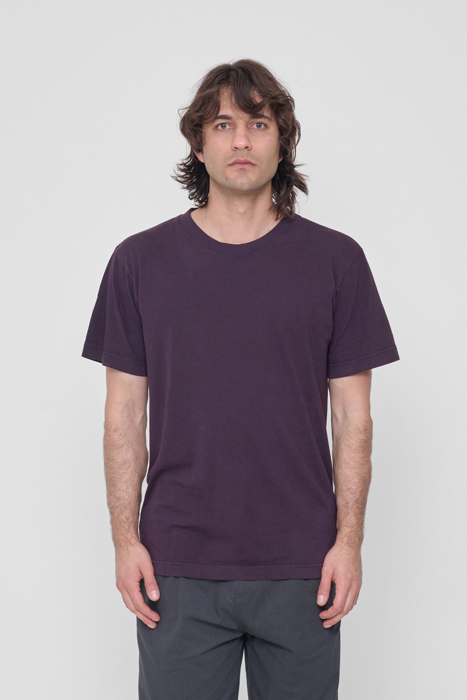 A 6'2" man in a size M Mulberry Short Sleeve Trash Tee. Hem at the lower hip.