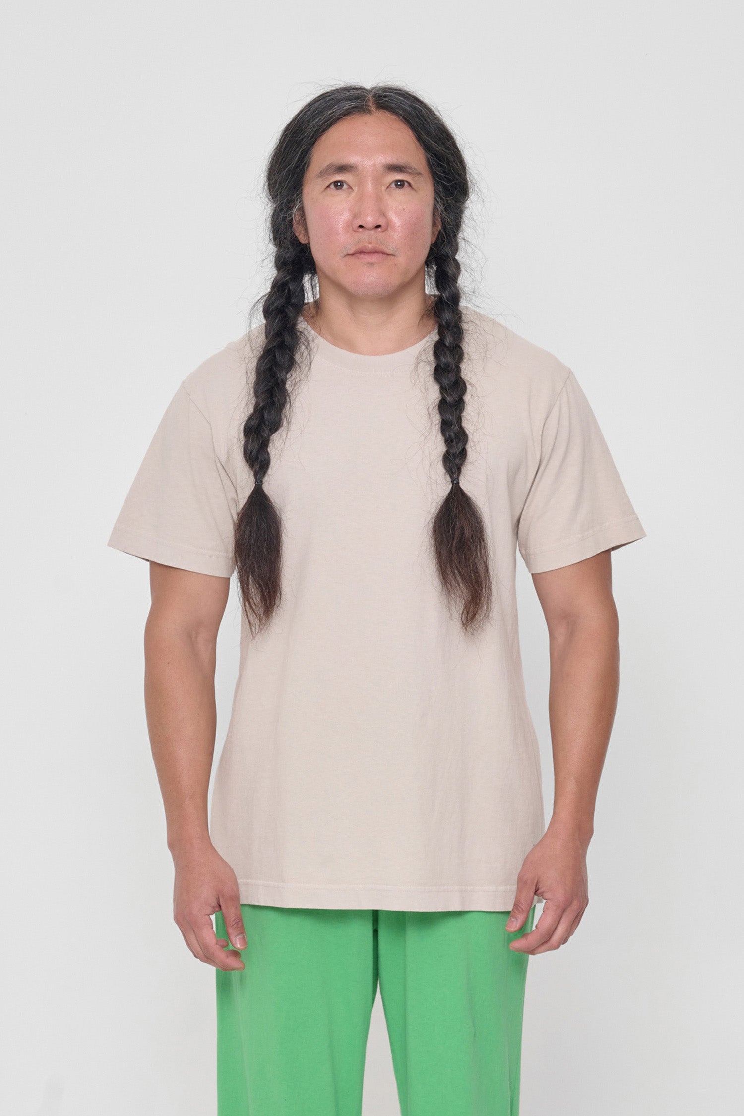 A 5'11" man in a size M Oat Short Sleeve Trash Tee. Hem just below the hip.