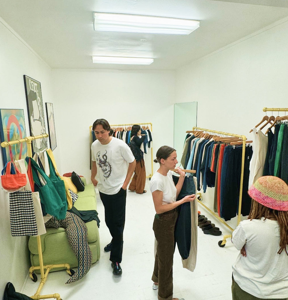 A diverse group of people shopping various clothing items at our Informal Shop