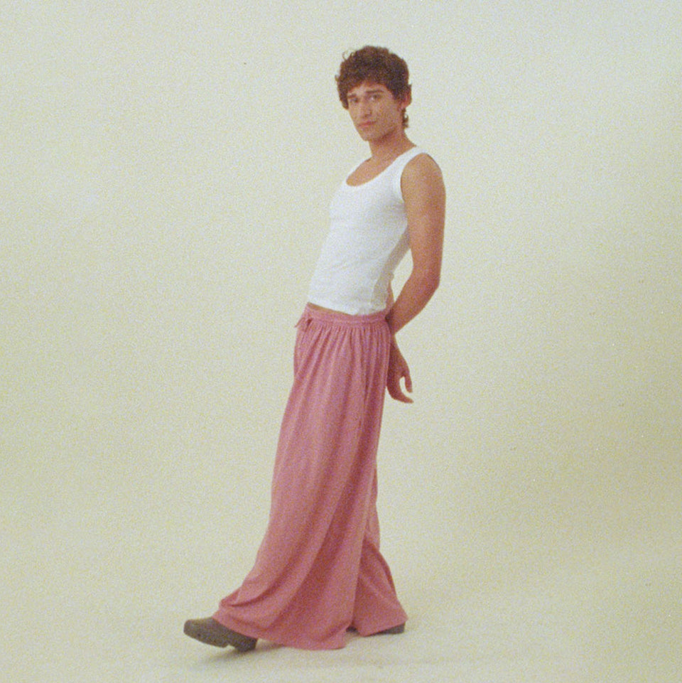 Person wearing a White Rib Tank and Wild Rose Tubular Pants on a plain background