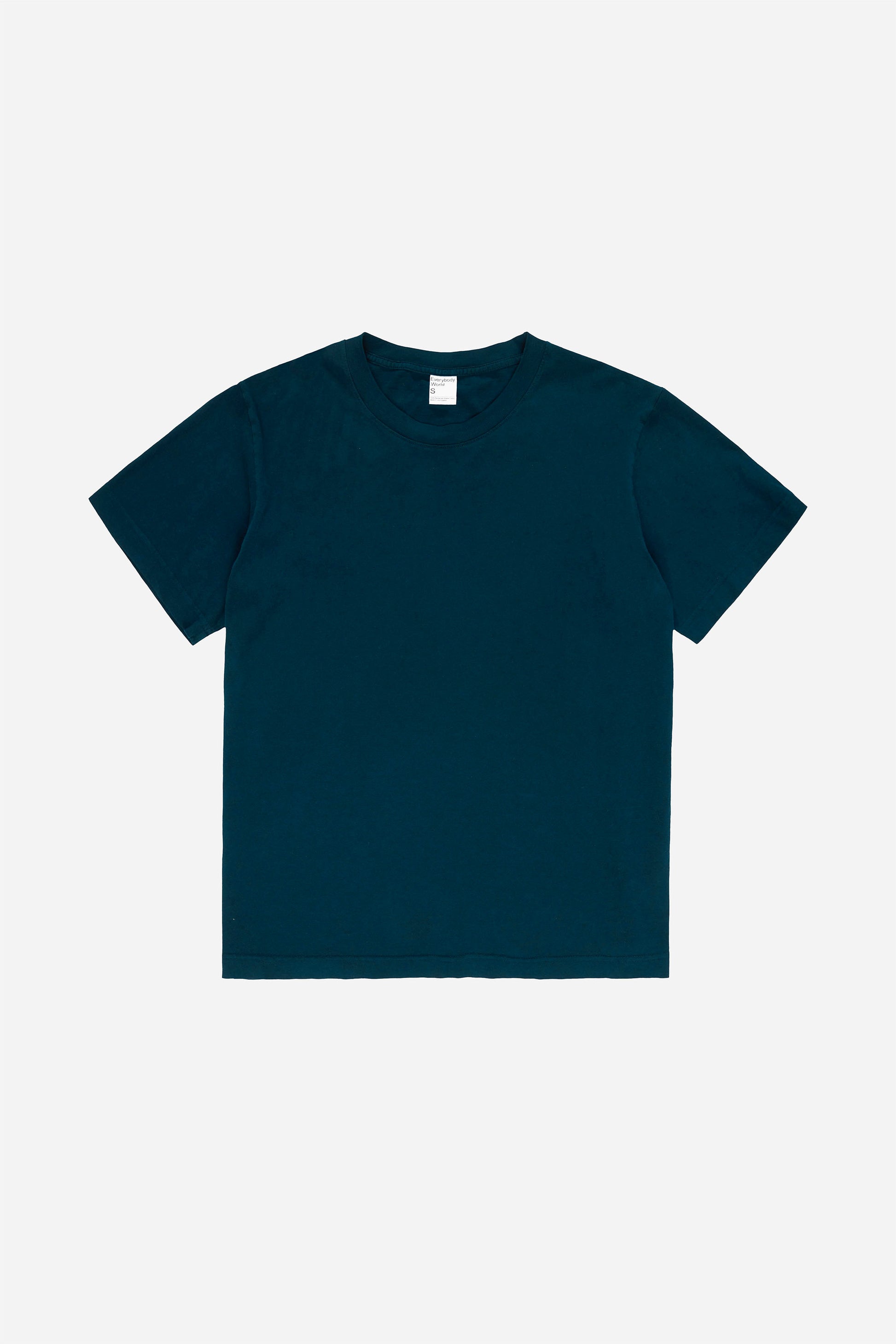 Flat lay of the Short Sleeve Trash Tee in Juniper, showing the classic cut of the dark teal  garment.