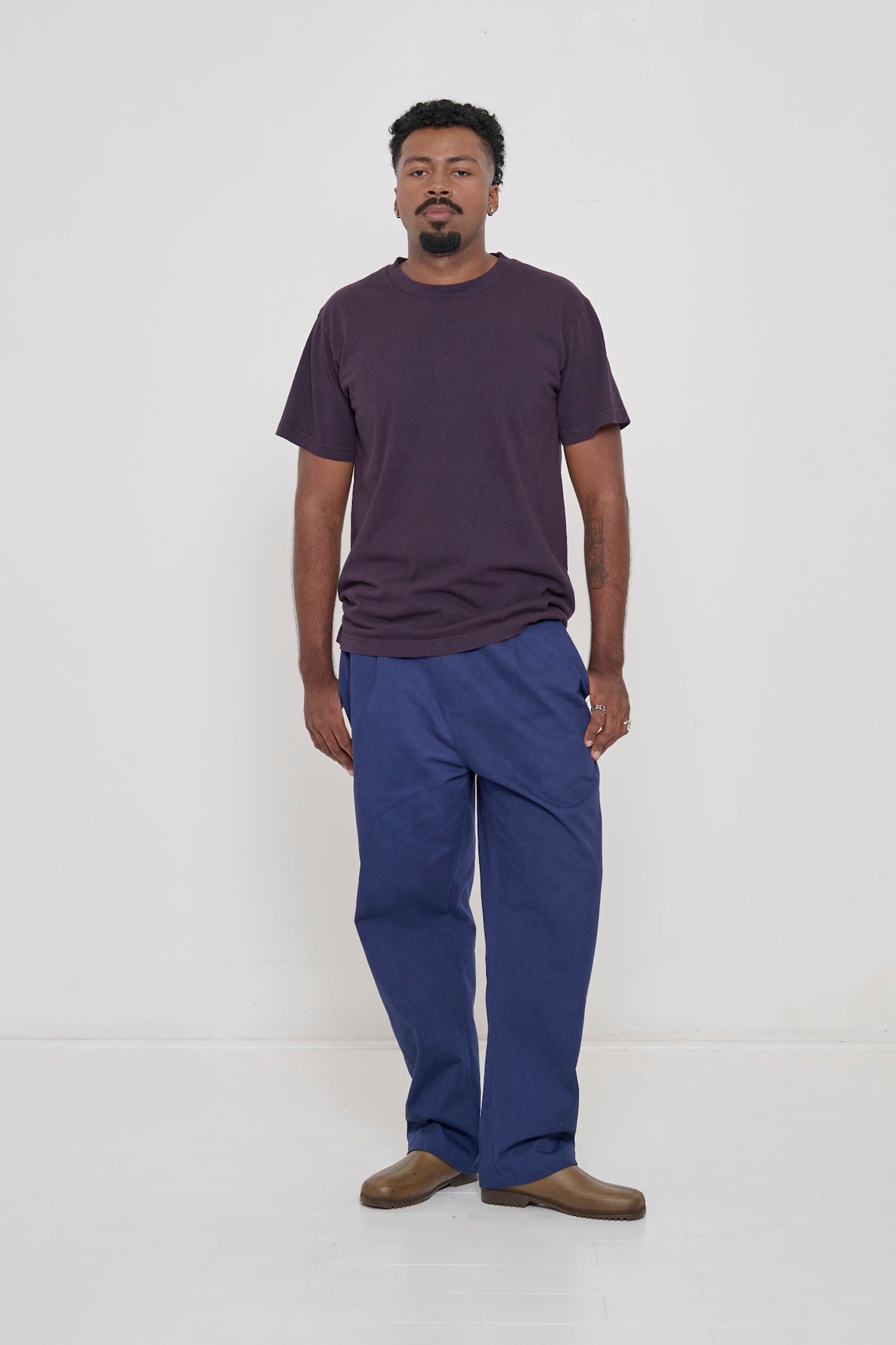 Front view of a man wearing the Short Sleeve Trash Tee in Mulberry and Washed Navy Cotton Twill Life Uniform Pants.