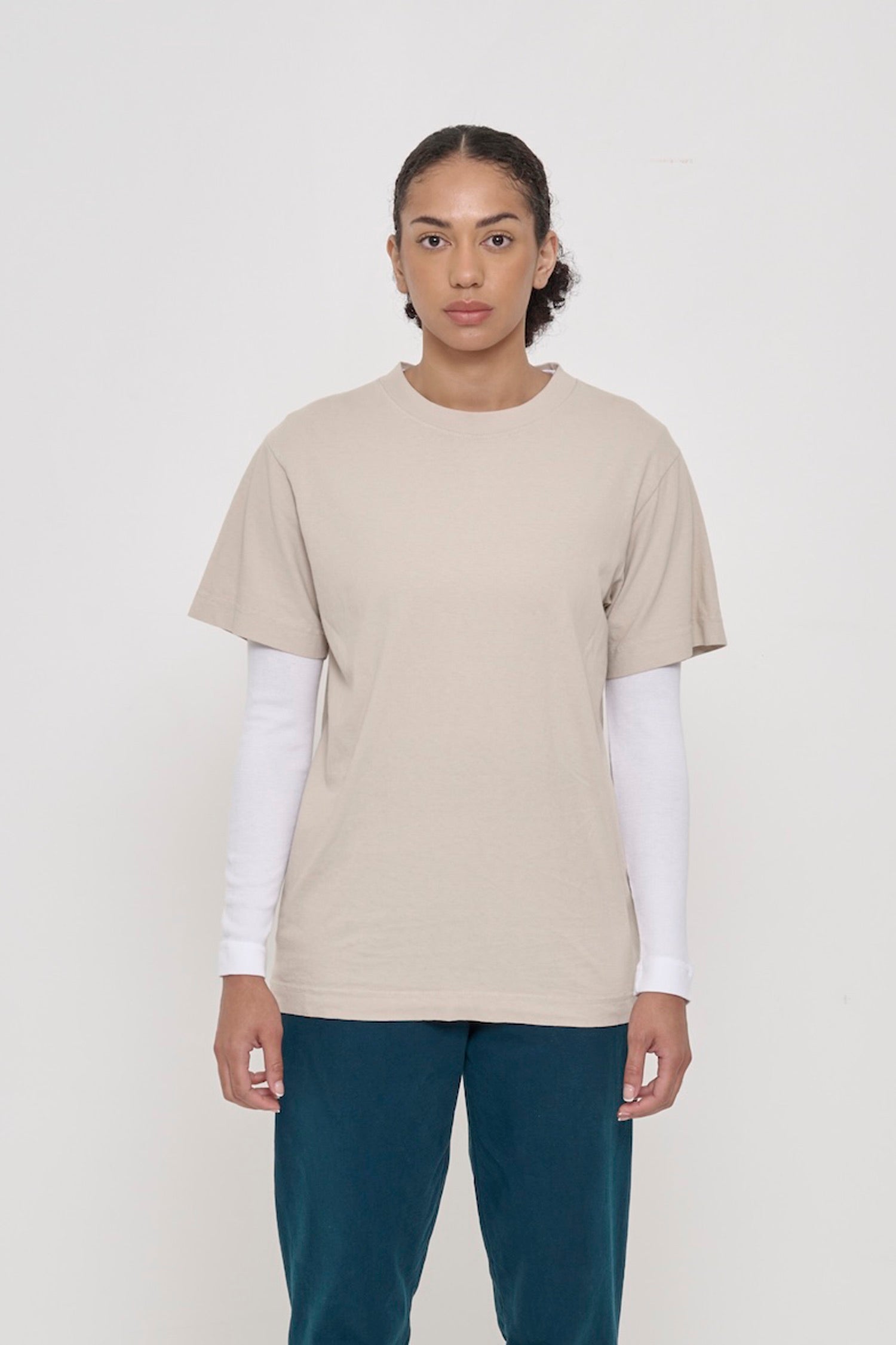 Front view of a woman wearing the Short Sleeve Trash Tee in Oat, showcasing its relaxed fit, hem hits below the hip.