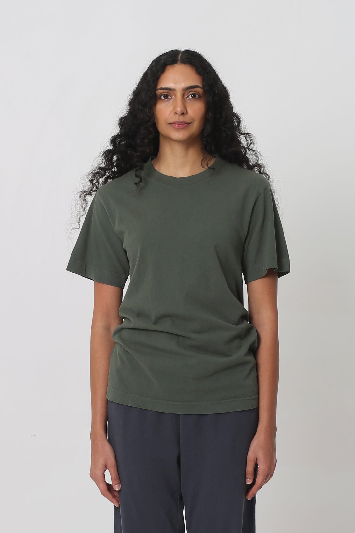 5'10" woman in a size S Pine Short Sleeve Trash Tee, scrunched up at the hip.
