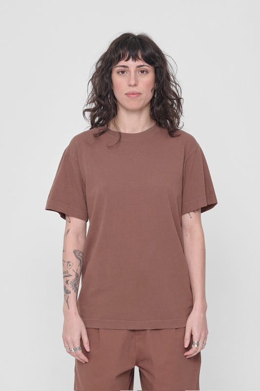 A 5'6" woman in a size S Potting Soil brown Short Sleeve Trash Tee. Hem at her lower hip.