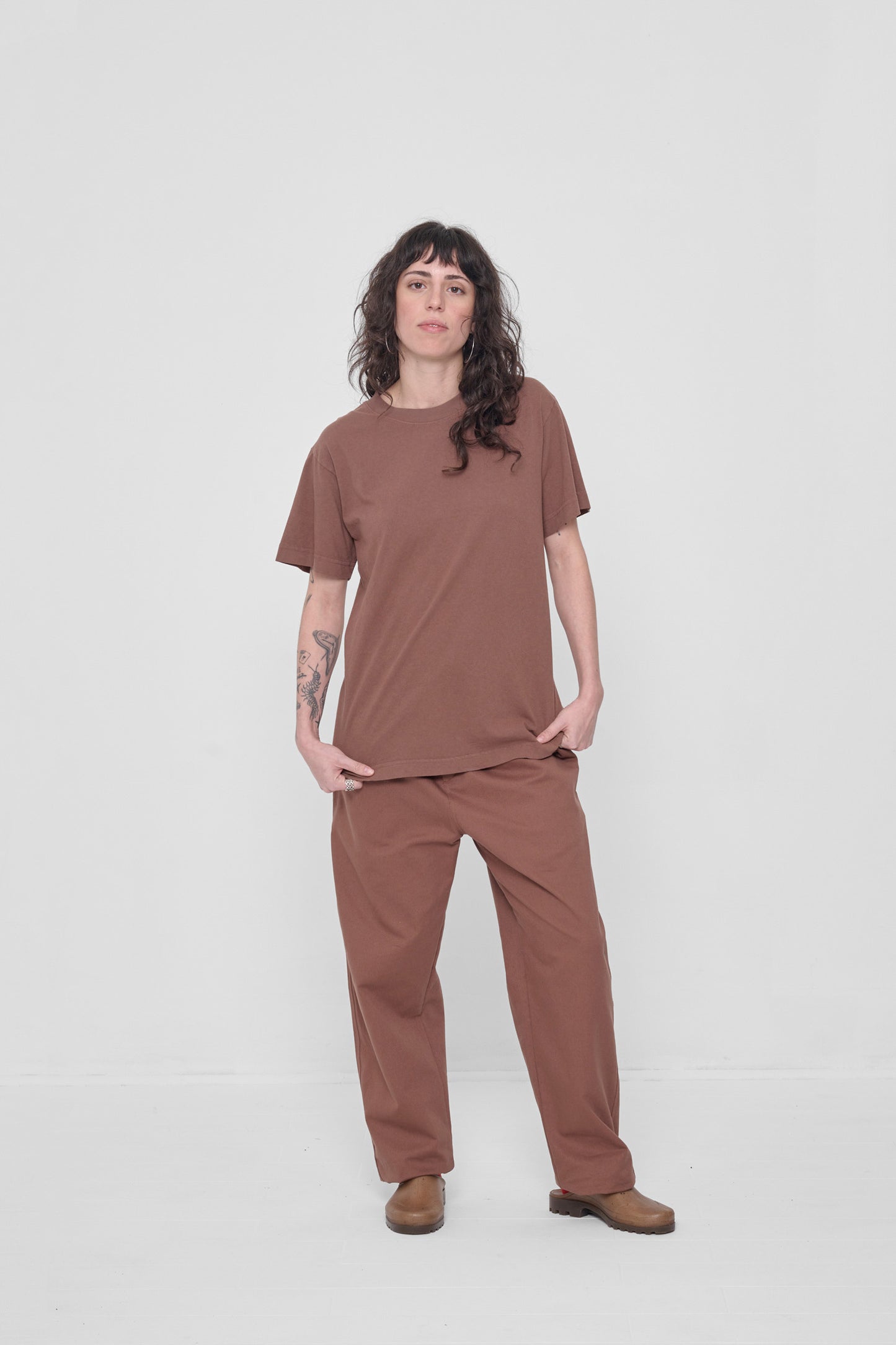 Styled untucked over matching Life Uniform Pants and Plasticana mules.