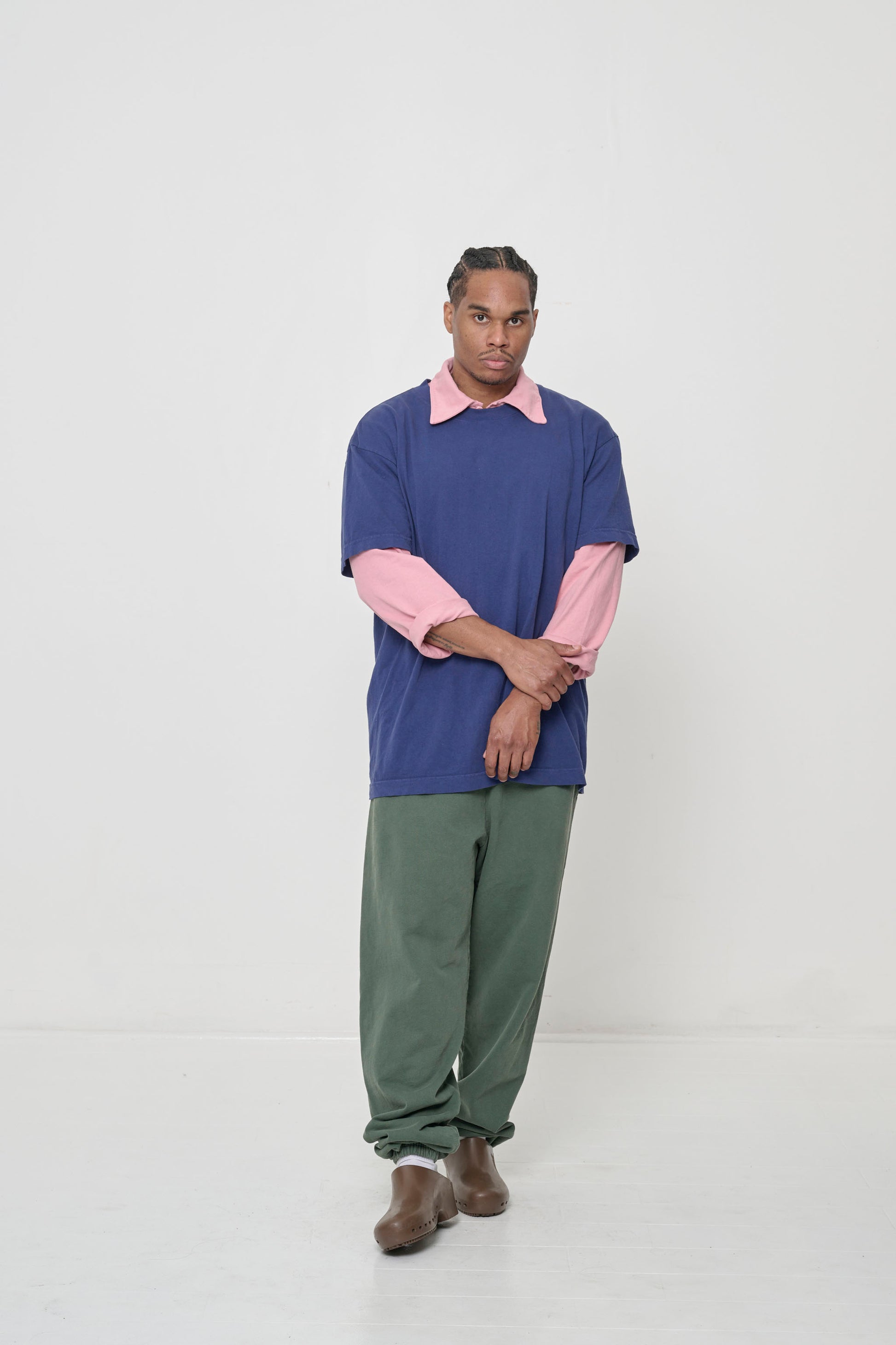 Worn over a pink long sleeve rugby polo shirt.