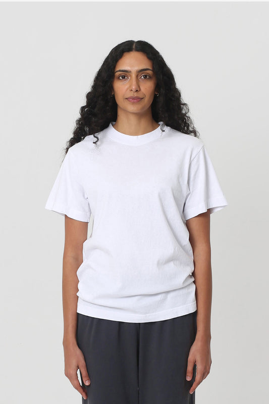 5'10" woman in a size S White Short Sleeve Trash Tee, scrunched up at the hip.