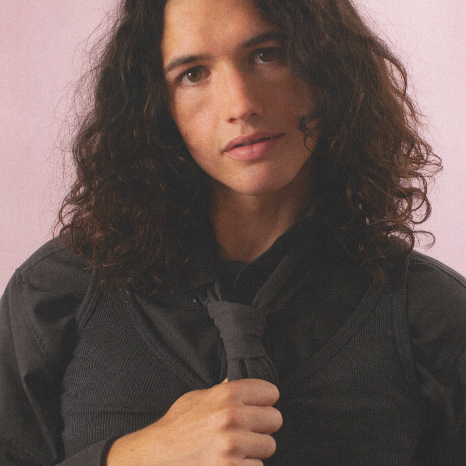 Close-up of a person wearing the Trash Tie, Rib tank, and Twill Button-Up Shirt all in Slate.