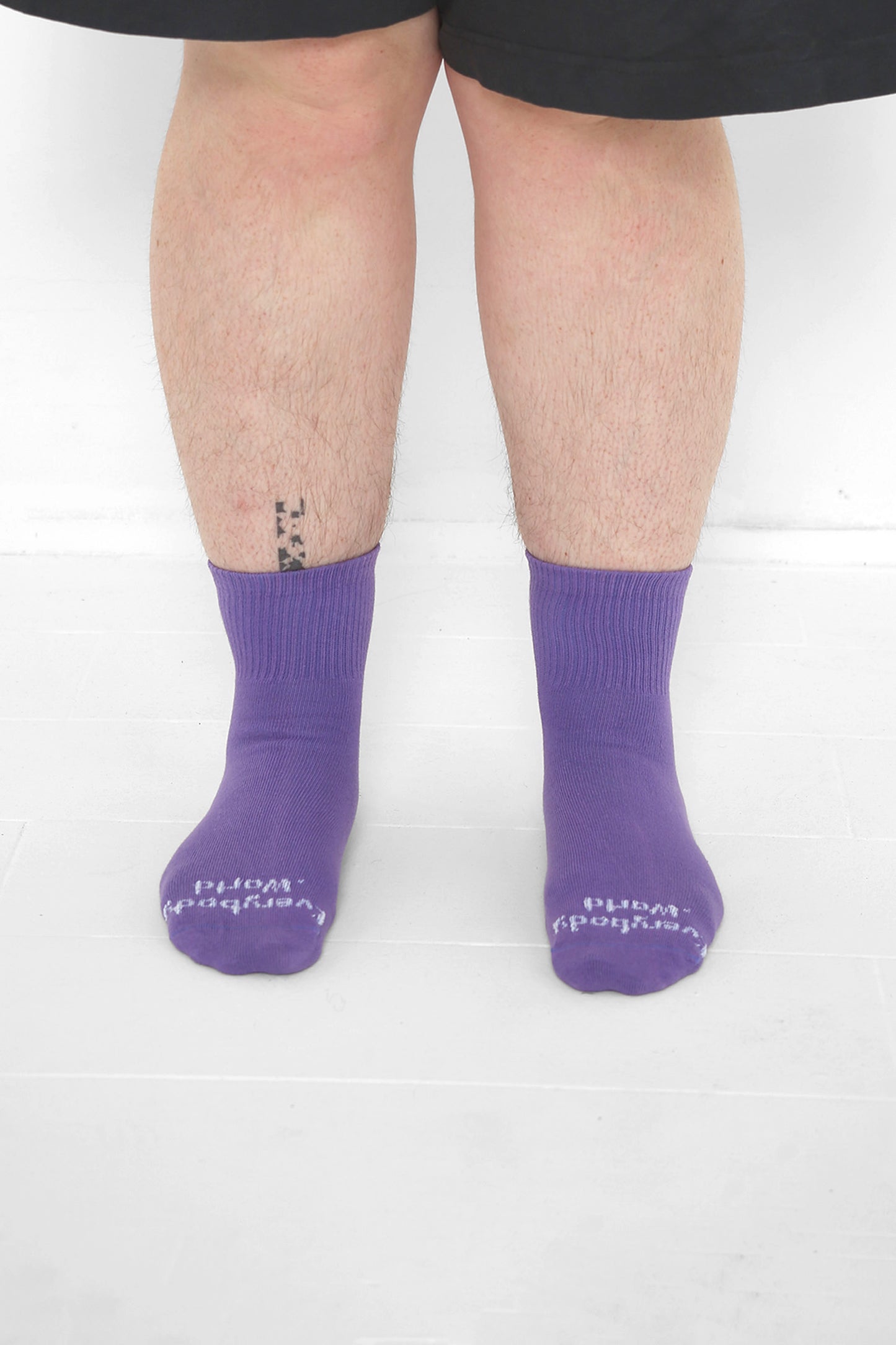 Carpe Diem Spring Socks, branded 'Everybody.World' in white, ankle-high, shown on lower legs.