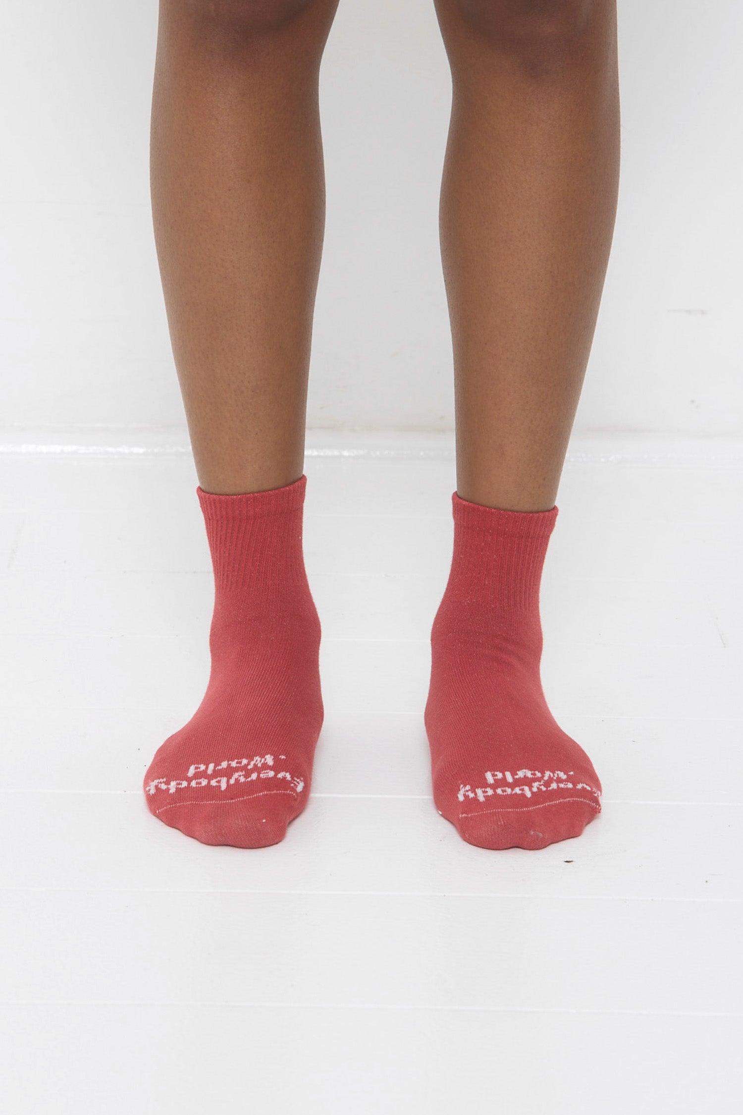 Red Cedar Spring Socks, branded 'Everybody.World' in white, ankle-high, on lower legs.