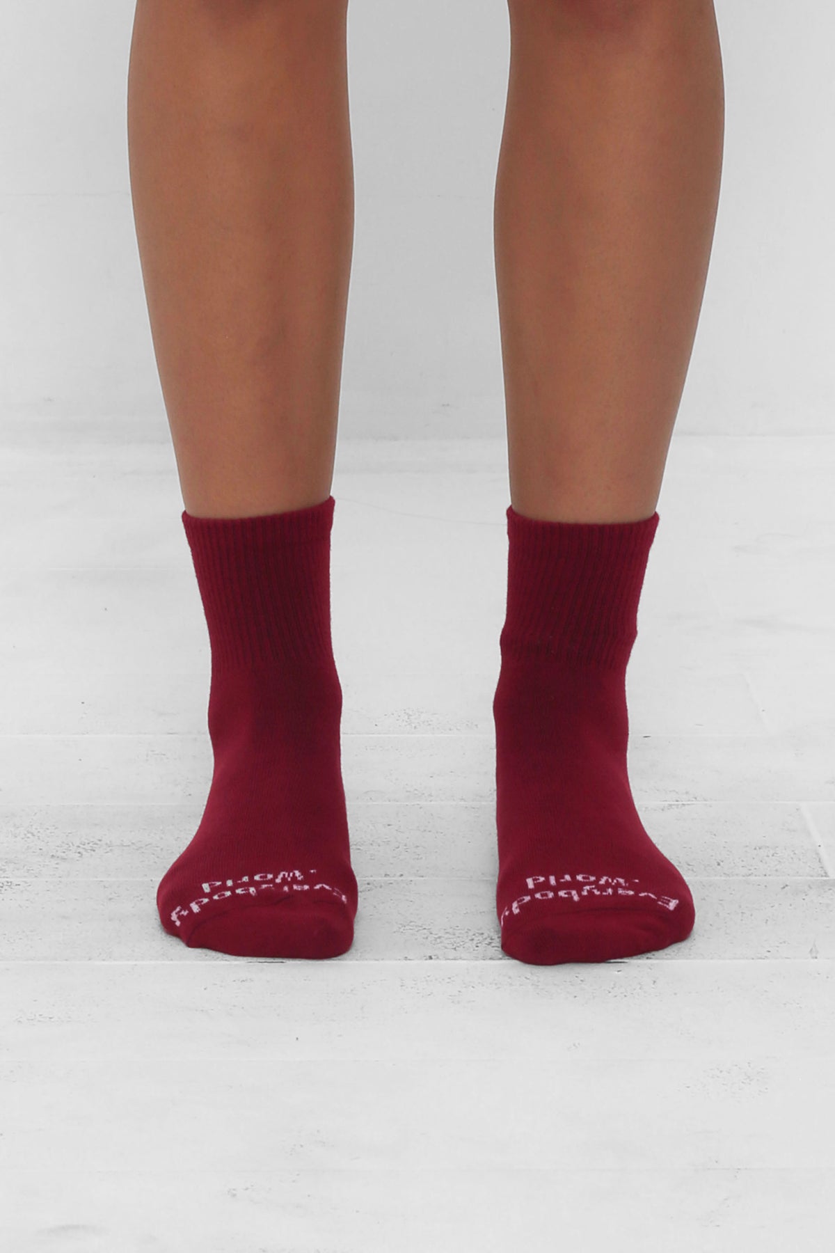 Garnet Spring Socks, branded 'Everybody.World' in white, ankle-high, shown on lower legs.