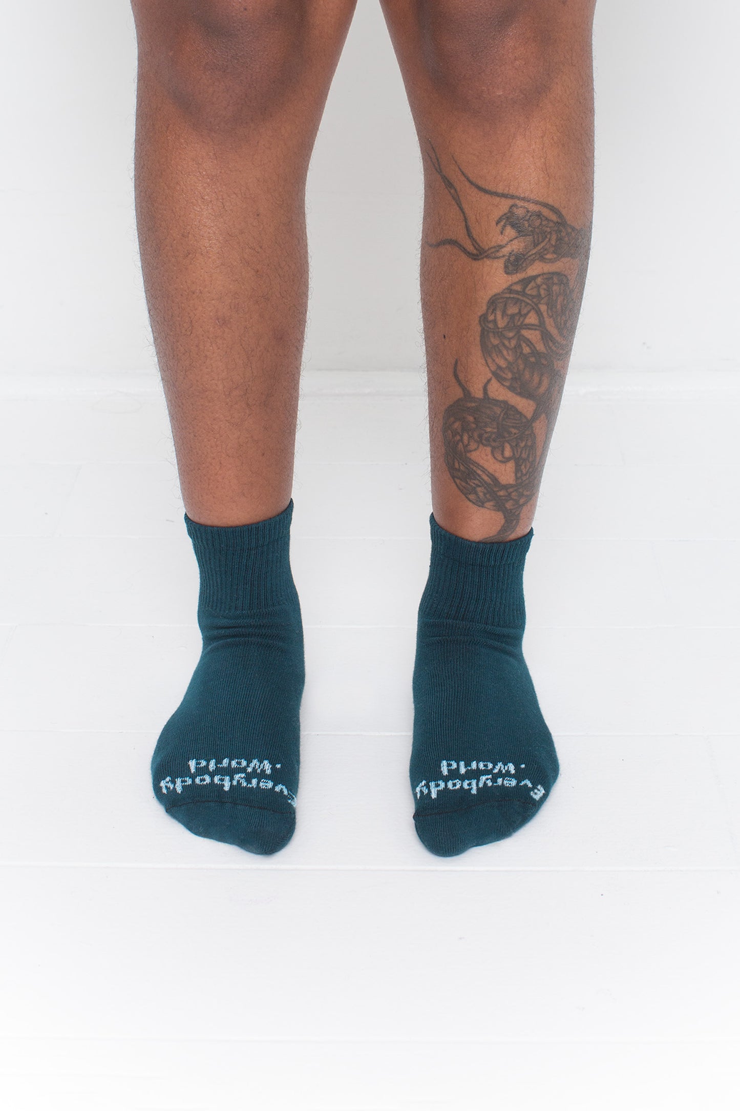 Juniper Spring Socks, branded 'Everybody.World' in white, are ankle-high, shown on a person's lower legs.