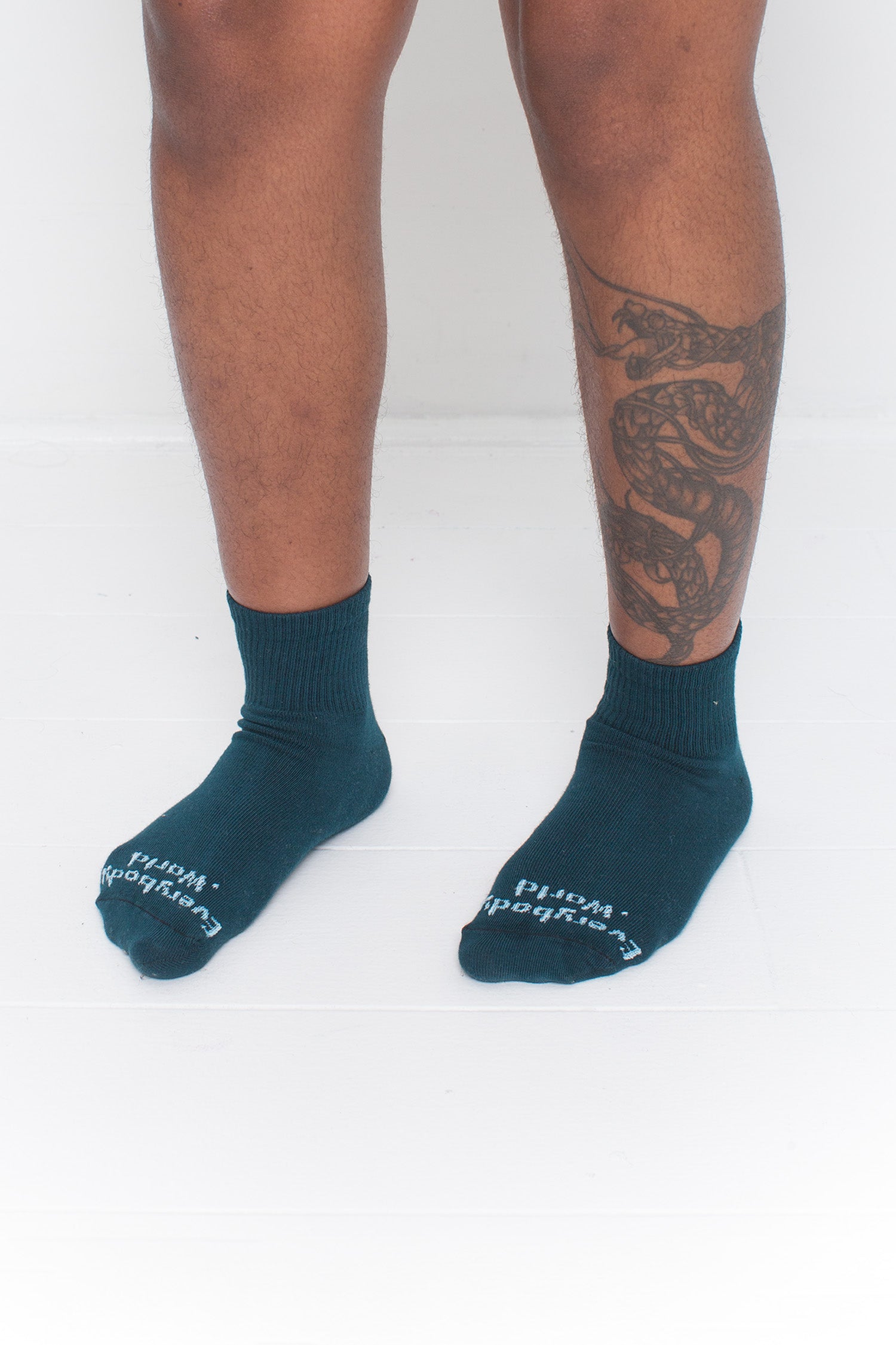 Juniper Spring Socks, branded 'Everybody.World,' shown on a person's lower legs pointing 45-degrees.