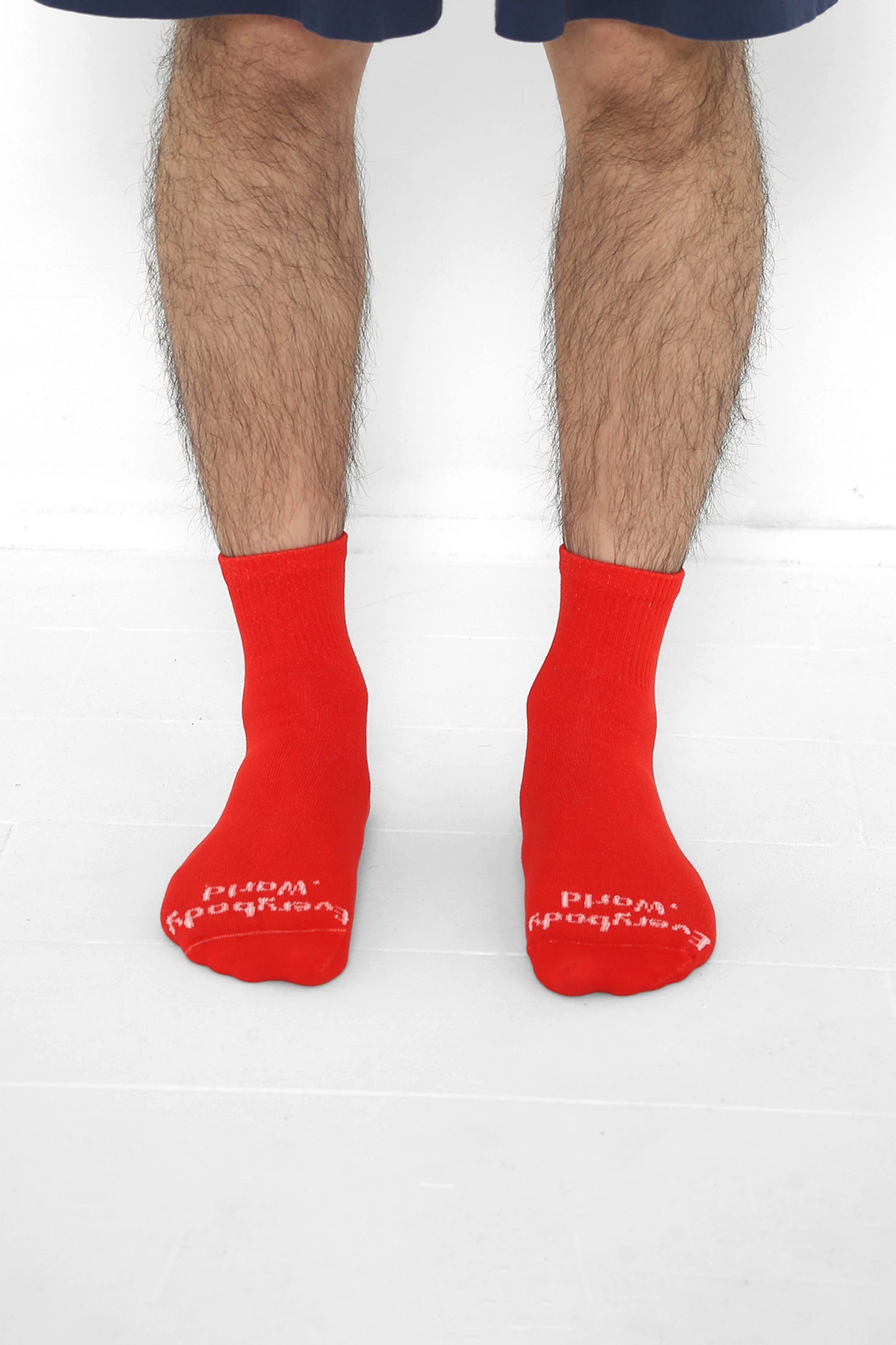 Lava Spring Socks, branded 'Everybody.World' in white, ankle-high, shown on lower legs.