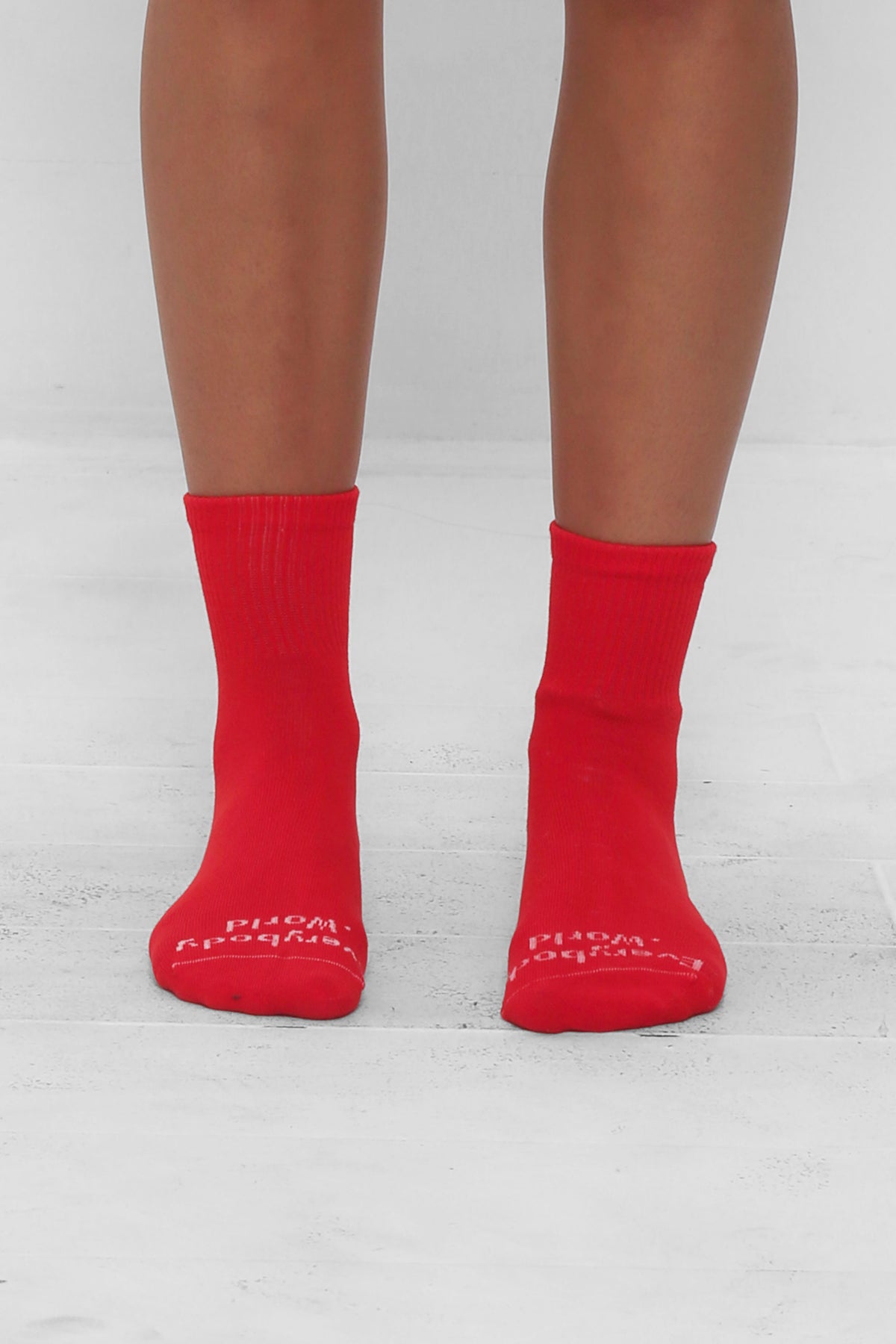 Lava Spring Socks, branded 'Everybody.World' in white, ankle-high, shown on lower legs.