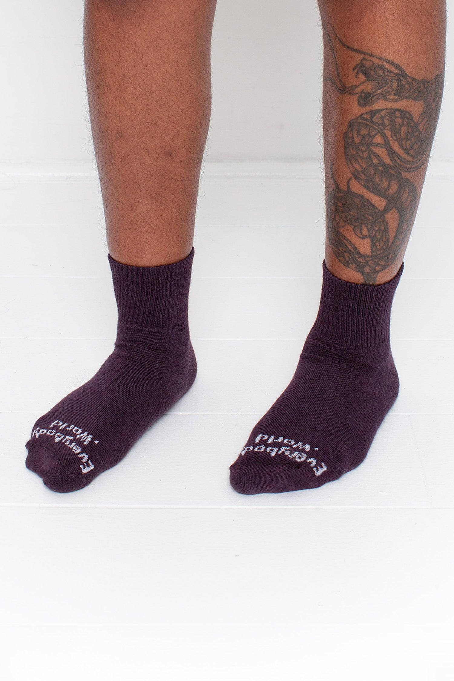Mulberry Spring Socks, branded 'Everybody.World,' shown on a person's lower legs pointing 45-degrees.
