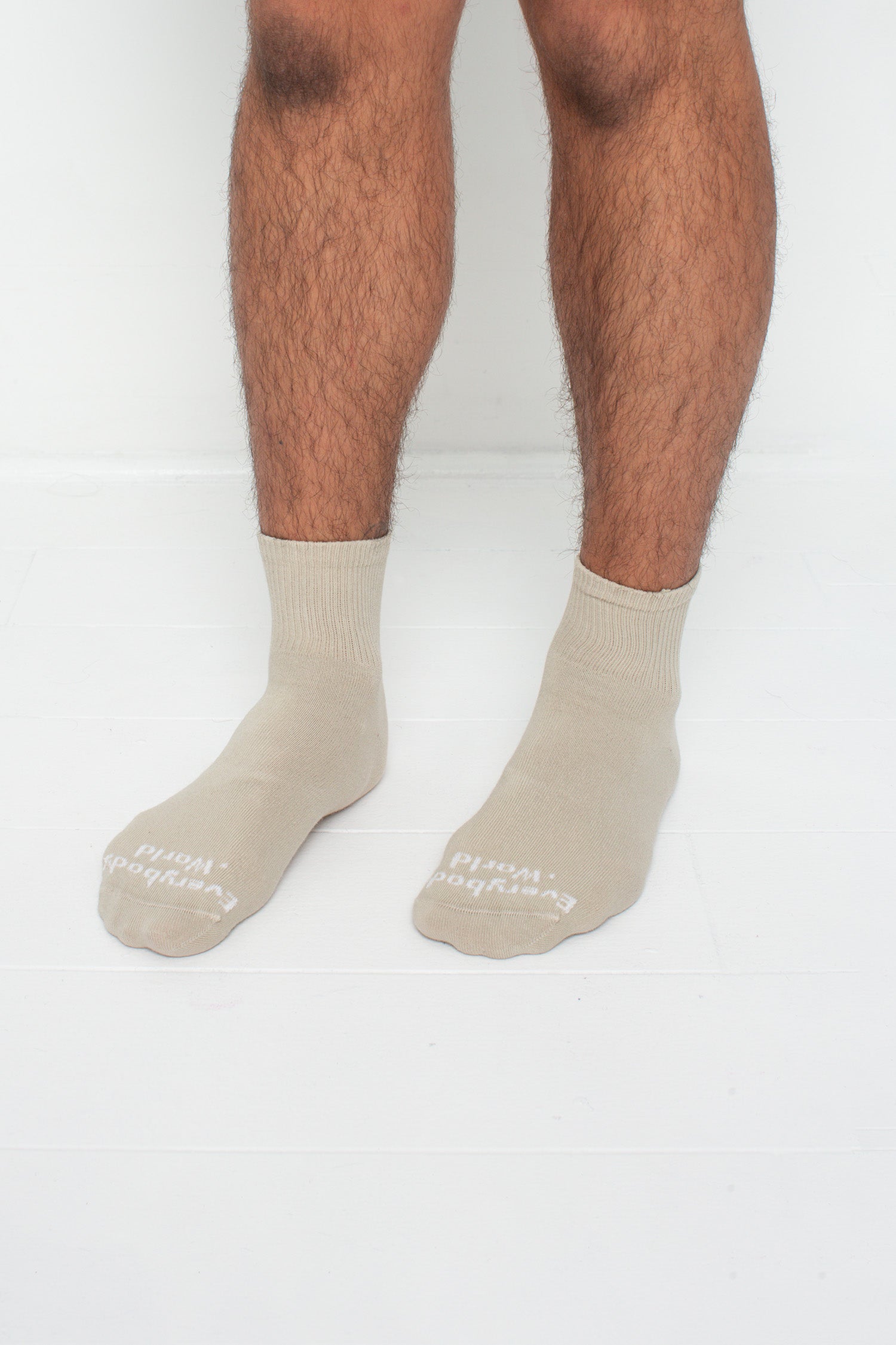Oat Spring Socks, branded 'Everybody.World,' shown on a person's lower legs pointing 45-degrees.