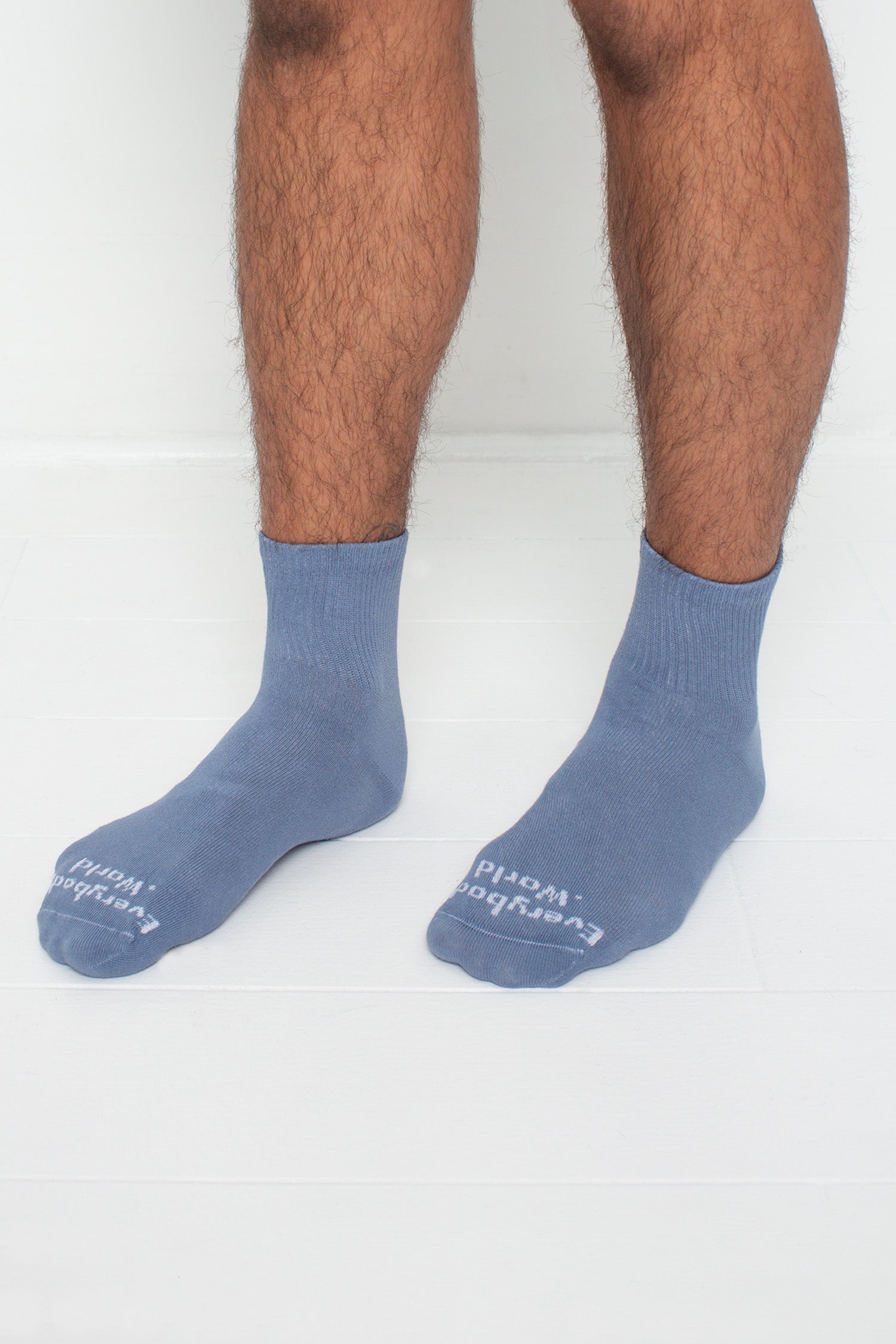 Periwinkle Spring Socks, branded 'Everybody.World,' shown on a person's lower legs pointing 45-degrees.