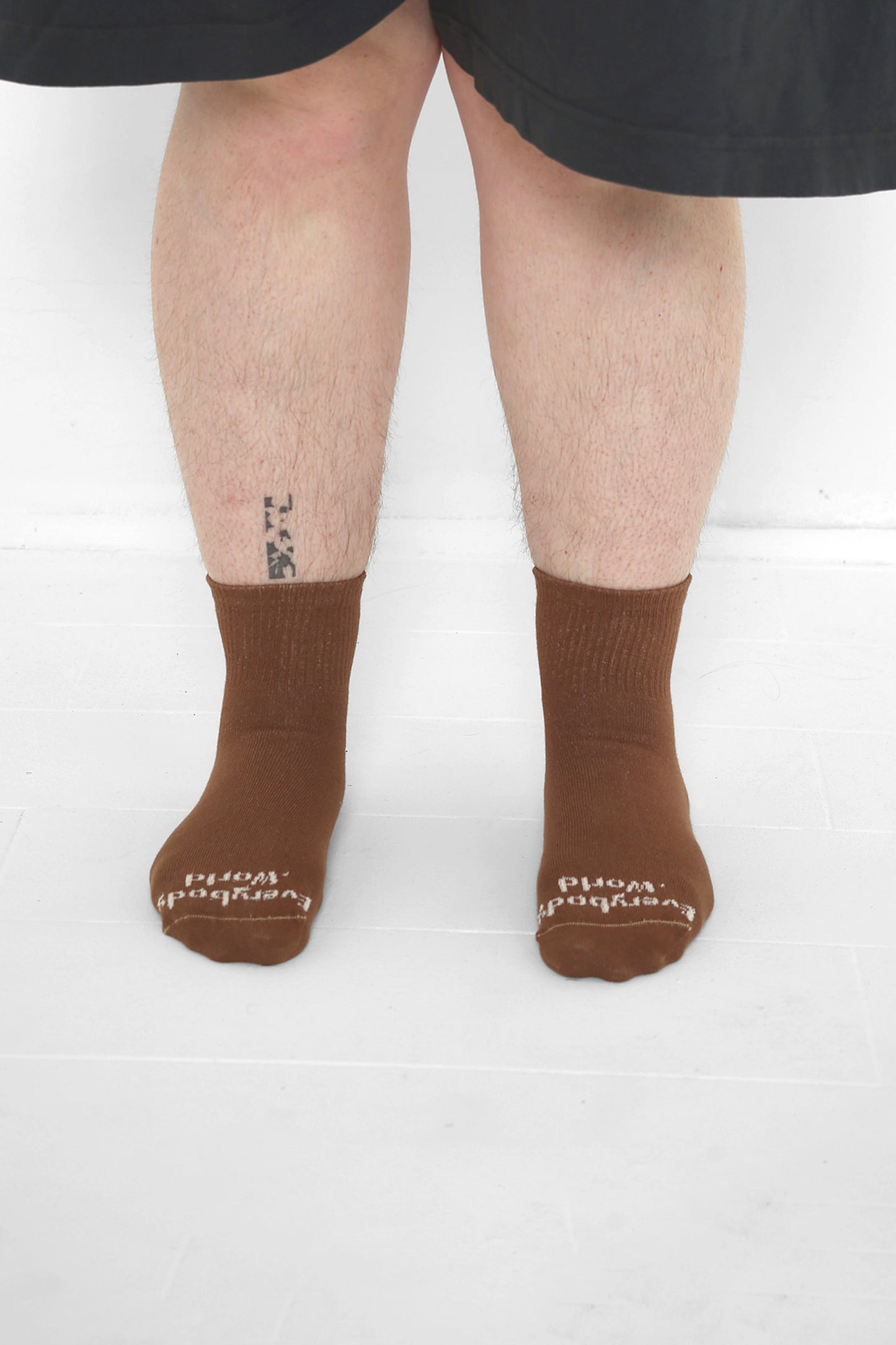 Potting Soil Spring Socks, branded 'Everybody.World' in white, ankle-high, shown on lower legs.