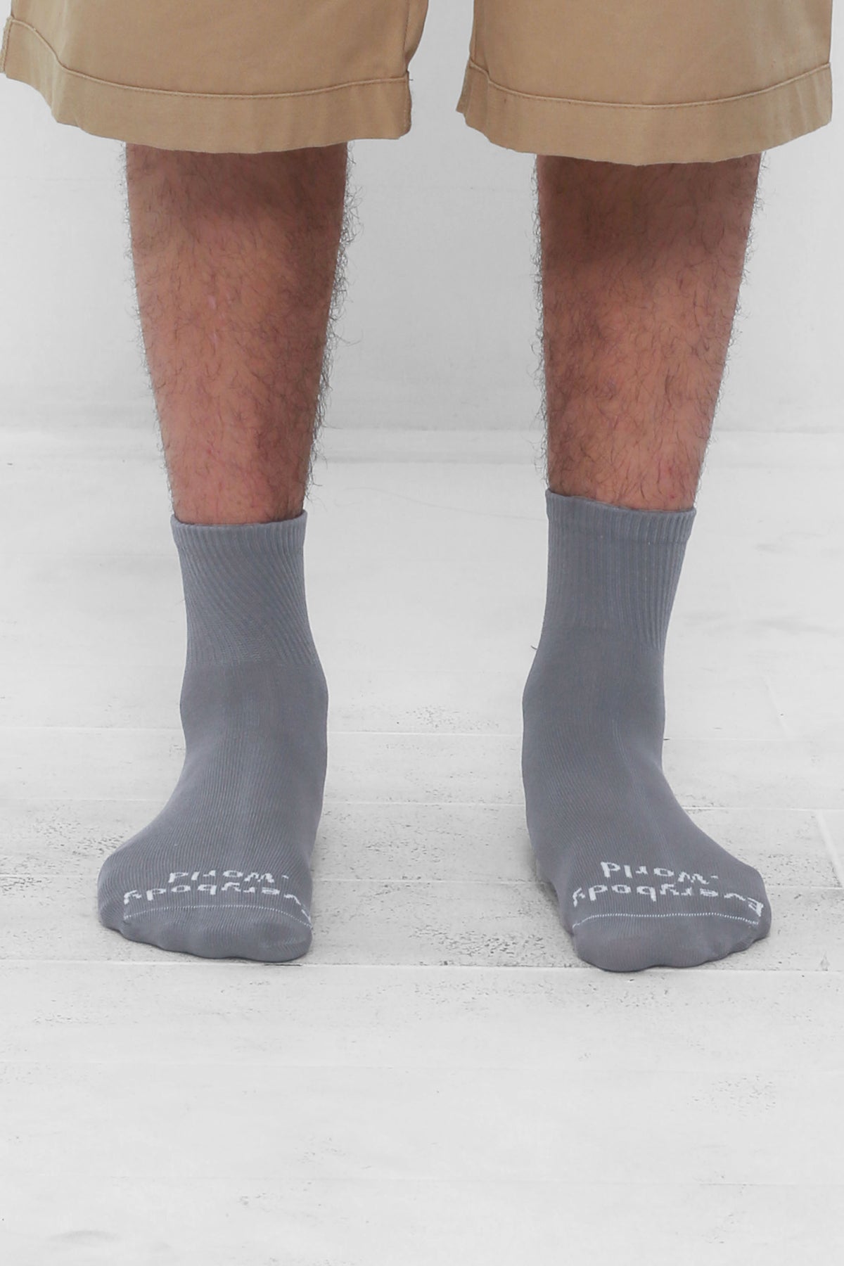 Stone Spring Socks, branded 'Everybody.World' in white, ankle-high, shown on lower legs.
