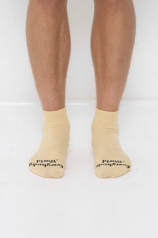 Turtle Dove Spring Socks, branded 'Everybody.World' in black, ankle-high, shown on lower legs.