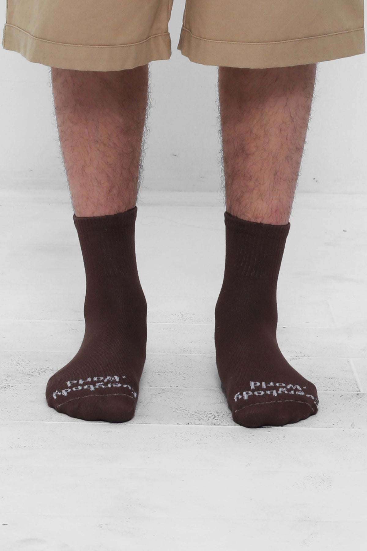 Wet Soil Spring Socks, branded 'Everybody.World' in white, ankle-high, shown on lower legs.