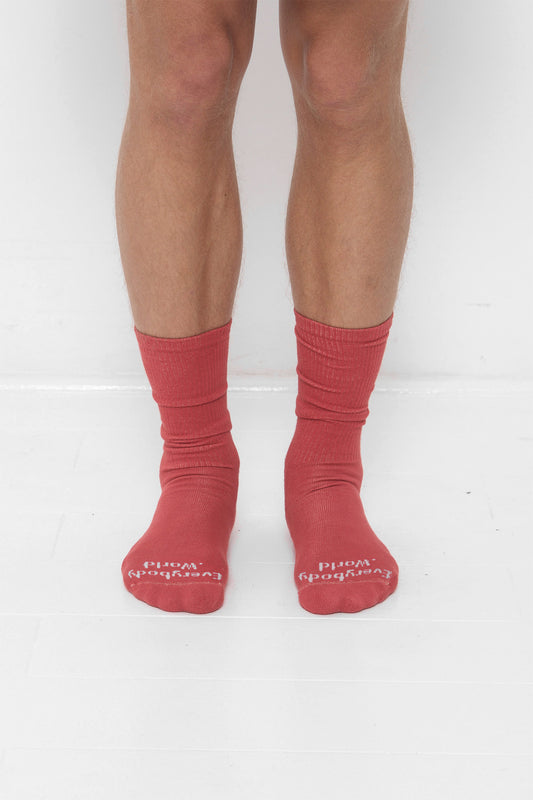 Cedar orange-red Spring Socks, branded 'Everybody.World' in white at the toe.