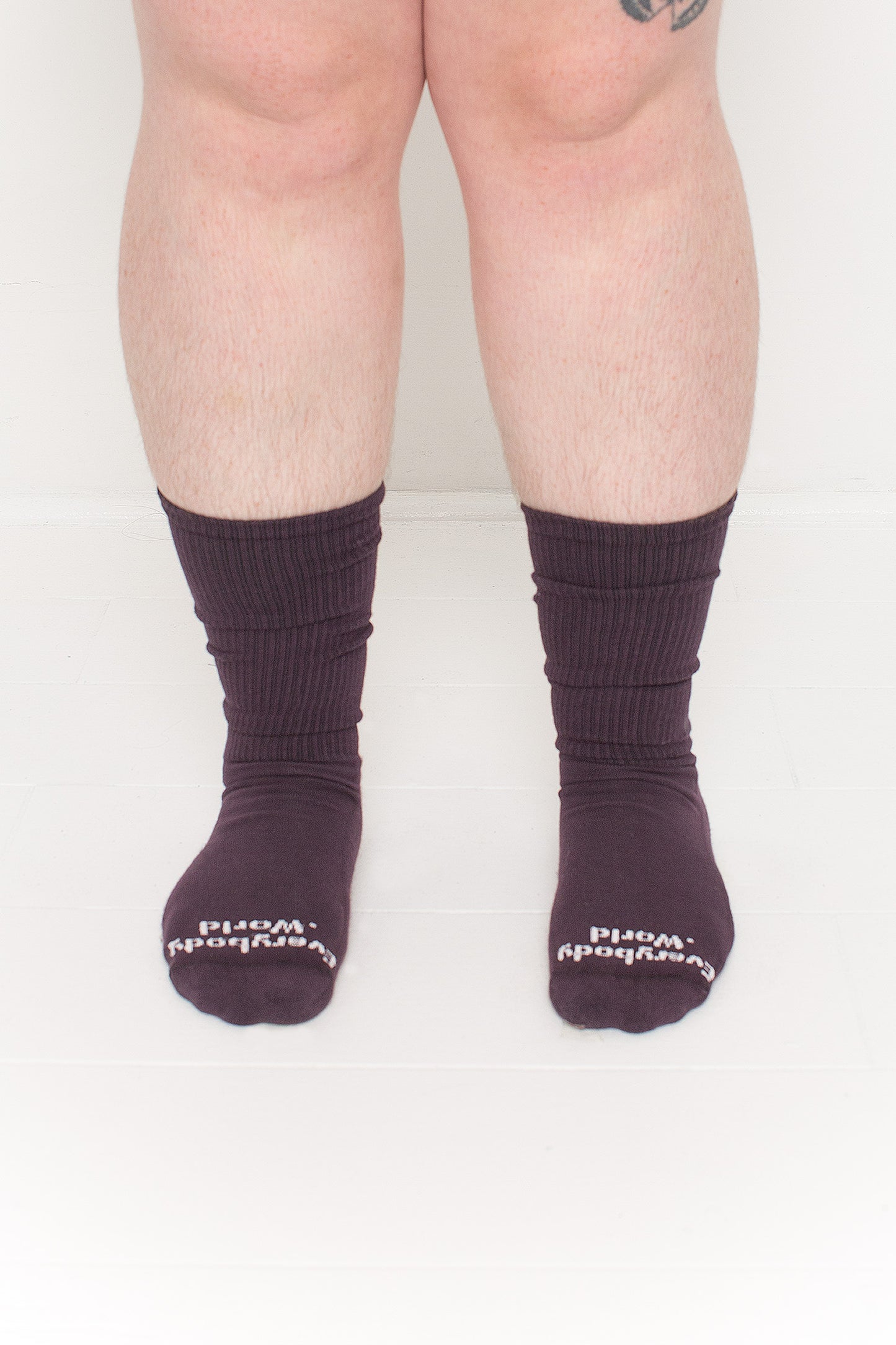 Mulberry Squishy Socks, branded 'Everybody.World' in white at the toe, shown on a person's lower legs.
