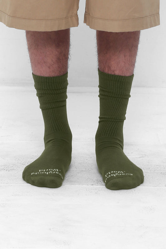 Olive Socks, branded 'Everybody.World' in white at the toe, mid-calf high.