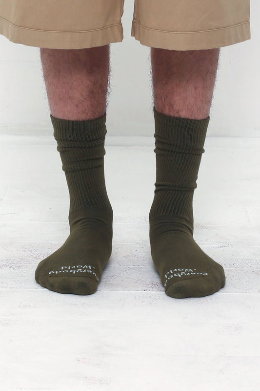 Olive Socks, branded 'Everybody.World' in white at the toe, mid-calf high.
