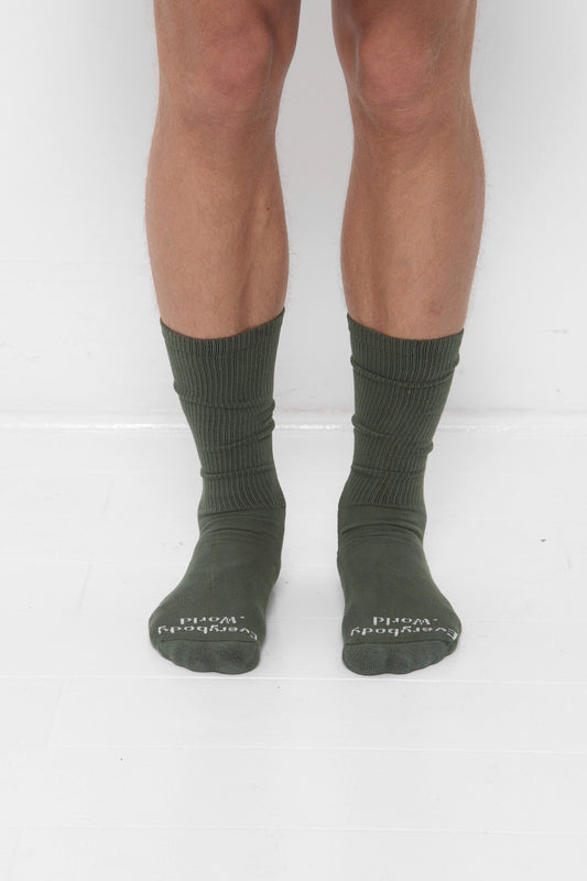 Pine green Squishy Socks, branded 'Everybody.World' in white at the toe.