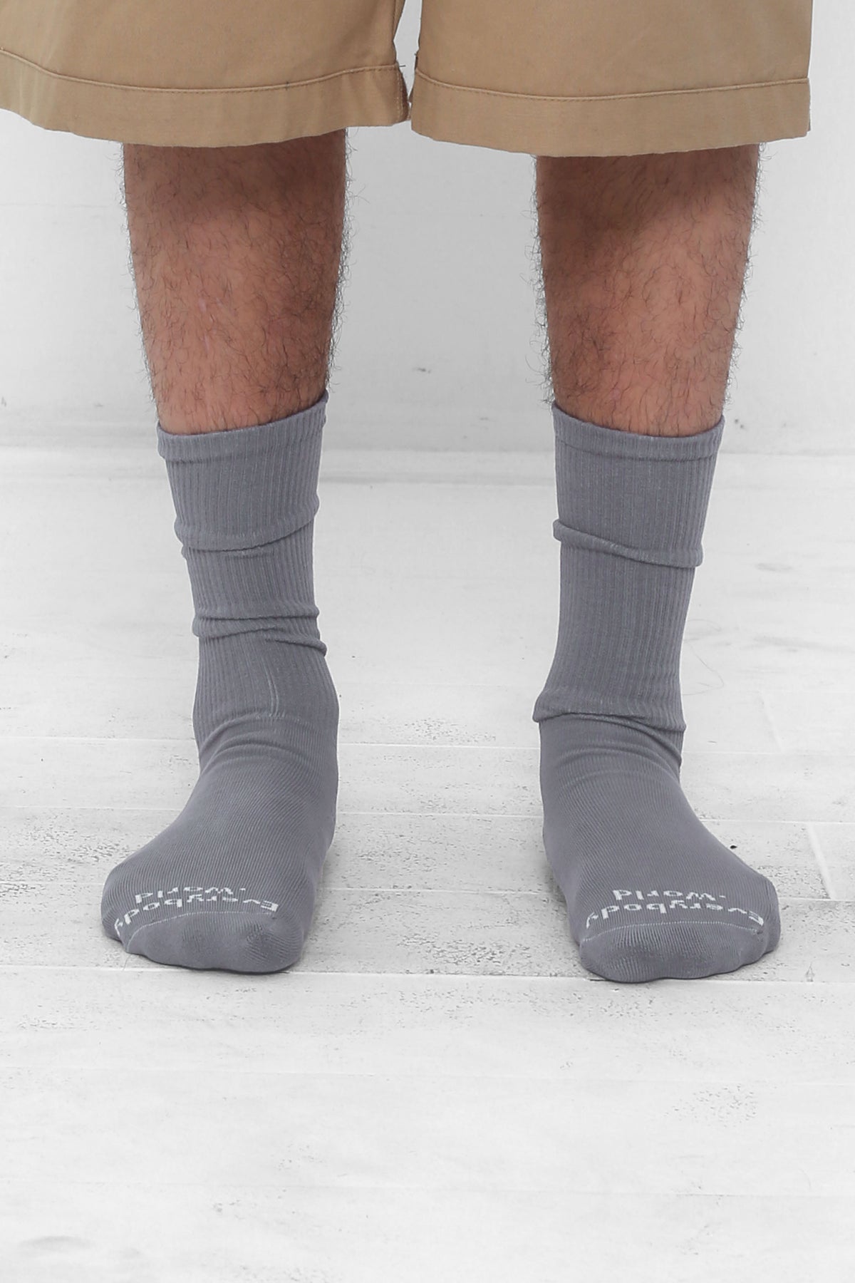 Stone Socks, branded 'Everybody.World' in white at the toe, mid-calf high.