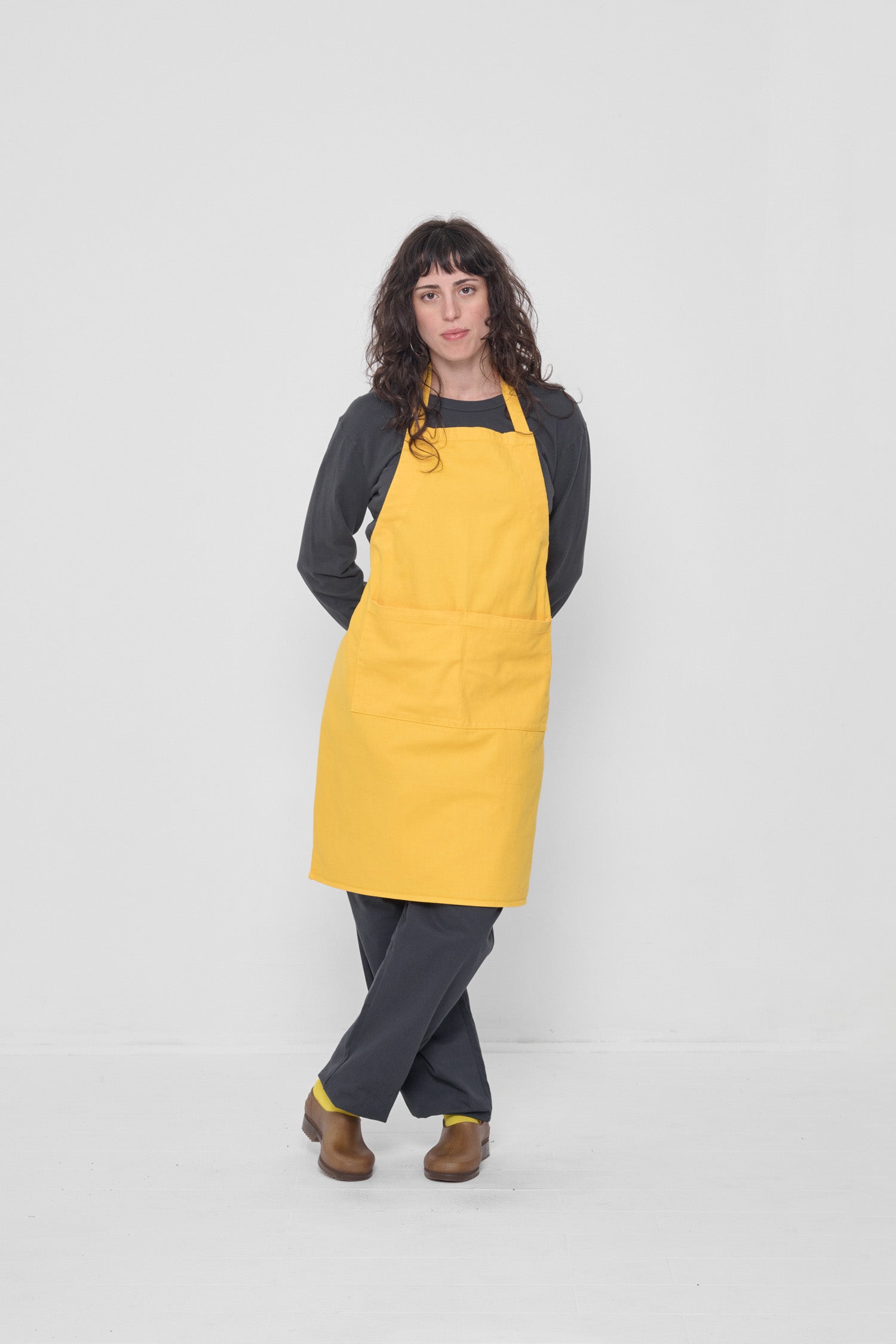 Styled under an Everybody Yellow Adjustable Apron and Slate Life Uniform Pants.