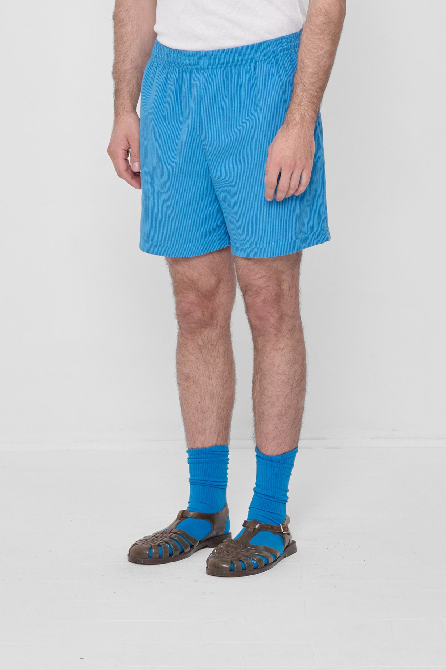 3/4 view highlights elastic waist and skinny blue and dark blue overdye stripes.